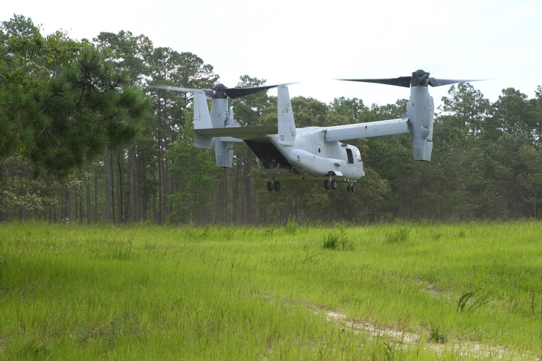 The V-22 Osprey prepares to land as students belonging to the Career Orientation Training for Midshipmen program, wait to board the aircraft. This is part of their training week aboard Camp Lejeune. Every summer the program brings groups of Naval Reserve Officers Training Corps students from colleges and universities all over the U.S. to Camp Lejeune to conduct Marine Week. CORTRAMID is an introduction for midshipmen to what the Marine Corps and the Navy have to offer the future officers. During the week they are aboard Lejeune, they participate in a variety of training activities from patrolling, live-fire exercises, flying in a military aircraft and learning about an array of military weapons systems.