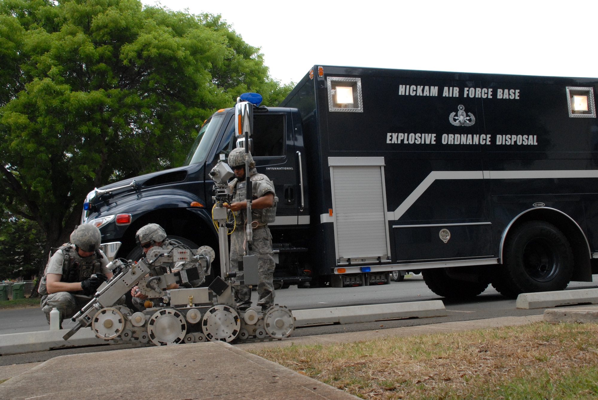 HICKAM AIR FORCE BASE, Hawaii – 15th Civil Engineer Squadron explosive ordnance disposal technicians prepare an electronic robot to enter a booby-trapped house on base during regular training June 22. From a distance, the robot controller can use the machine to shoot or detonate anything that may be too dangerous for an EOD tech in a bomb suit to approach. The EOD career field was named Air Force Team of the Year for the first time in 2009 for clearing more roadside bombs than any other service in Iraq and Afghanistan - 1,915, according to Air Force officials. (U.S. Air Force photo/Senior Airman Carolyn Viss)