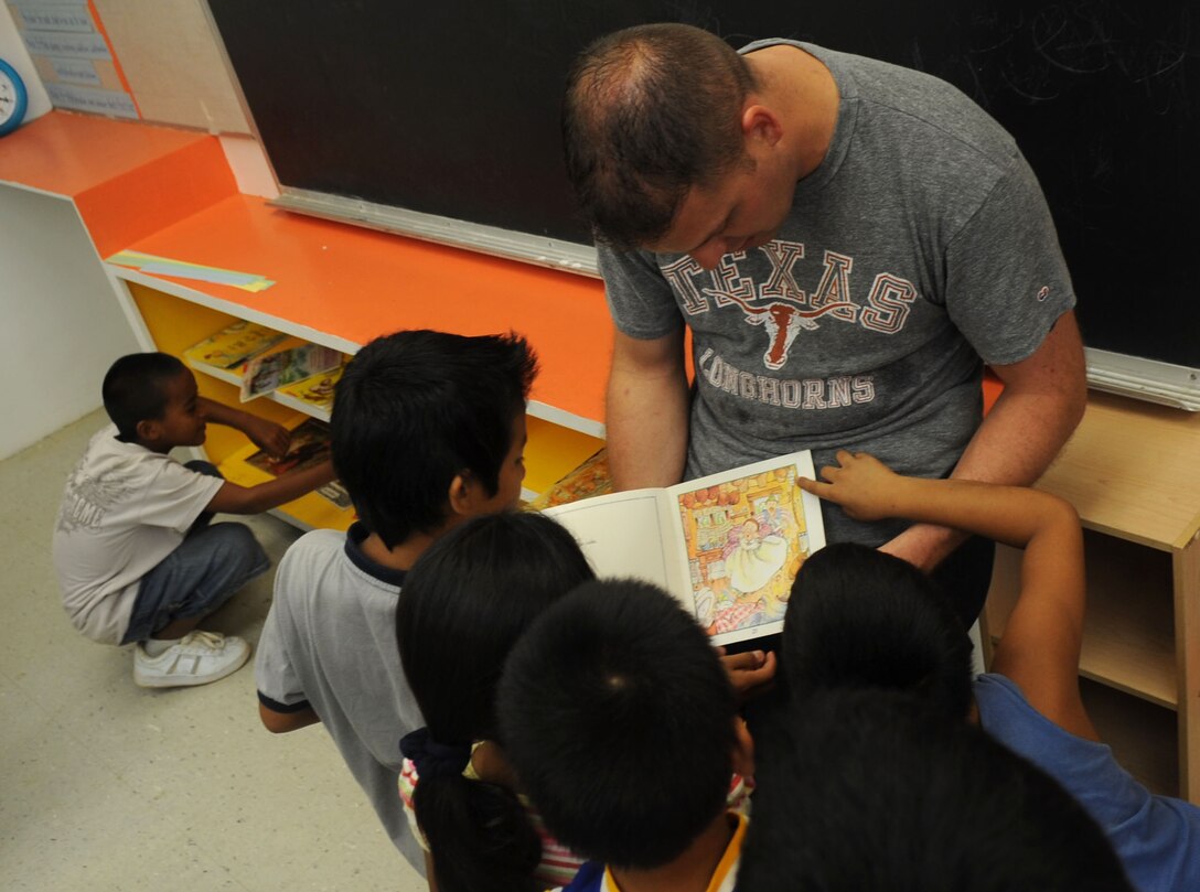 Staff Sgt. FrankRuckel, 3rd Expeditionary Maintenance Unit aircraft metals technologist, reads to some of the third and fourth graders at Machananao Elementary School.  The Dripping Springs, Texas, native is deployed to Andersen Air Force Base from Elmendorf AFB, Alaska, to support U.S. Pacific Command's Continuous Bomber Presence in the Asia-Pacific Region. (U.S. Air Force photo/Senior Airman Christopher Bush)
