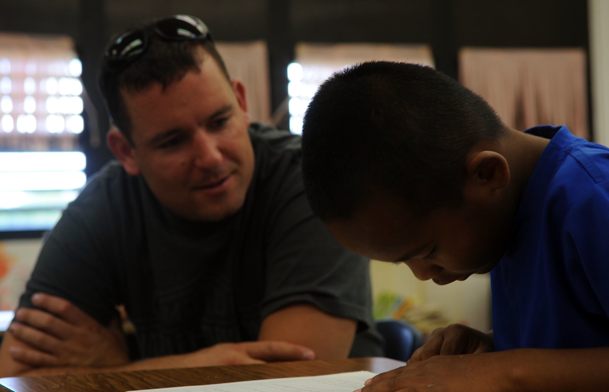 Technical Sgt. Sean Burger, 525th Expeditionary Aircraft Maintenance Unit  F-22 Raptor low observables aircraft structural maintenance craftsman, reads to second graders at Machananao Elementary School.  The Weippe, Idaho, native is deployed here to Andersen Air Force Base from Elmendorf AFB, Alaska, to support U.S. Pacific Command's Continuous Bomber Presence in the Asia-Pacific Region.(U.S. Air Force photo/Senior Airman Christopher Bush)
