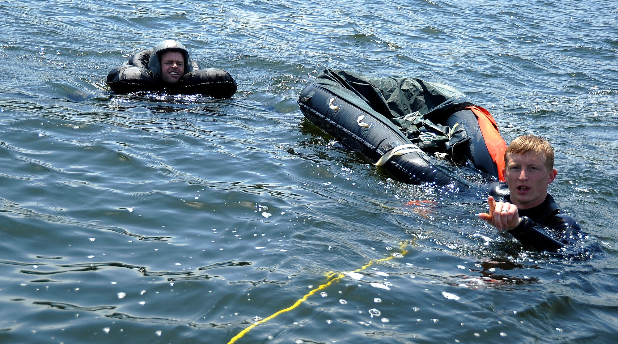 MISAWA AIR BASE, Japan -- Staff Sgt. Benjamin Thomas, 35th Operations Support Squadron, Survival, Evasion, Resistance and Escape specialist, trains Maj. Wesley Hales, 13th Fighter Squadron pilot, on basic water survival skills during water survival training at Lake Ogawara June 24, 2009.  Pilots must undergo this training annually to remain proficient in these skills. (U.S. Air Force photo by Senior Airman Chad C. Strohmeyer)