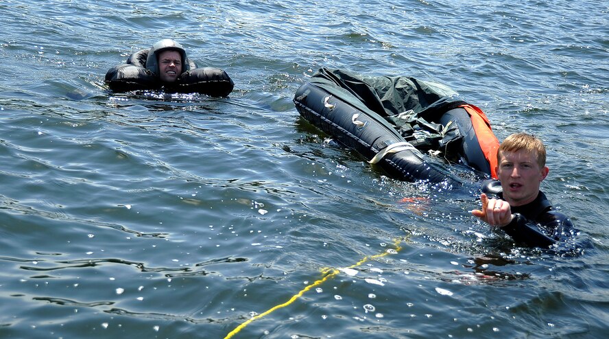 MISAWA AIR BASE, Japan -- Staff Sgt. Benjamin Thomas, 35th Operations Support Squadron, Survival, Evasion, Resistance and Escape specialist, trains Maj. Wesley Hales, 13th Fighter Squadron pilot, on basic water survival skills during water survival training at Lake Ogawara June 24, 2009.  Pilots must undergo this training annually to remain proficient in these skills. (U.S. Air Force photo by Senior Airman Chad C. Strohmeyer)