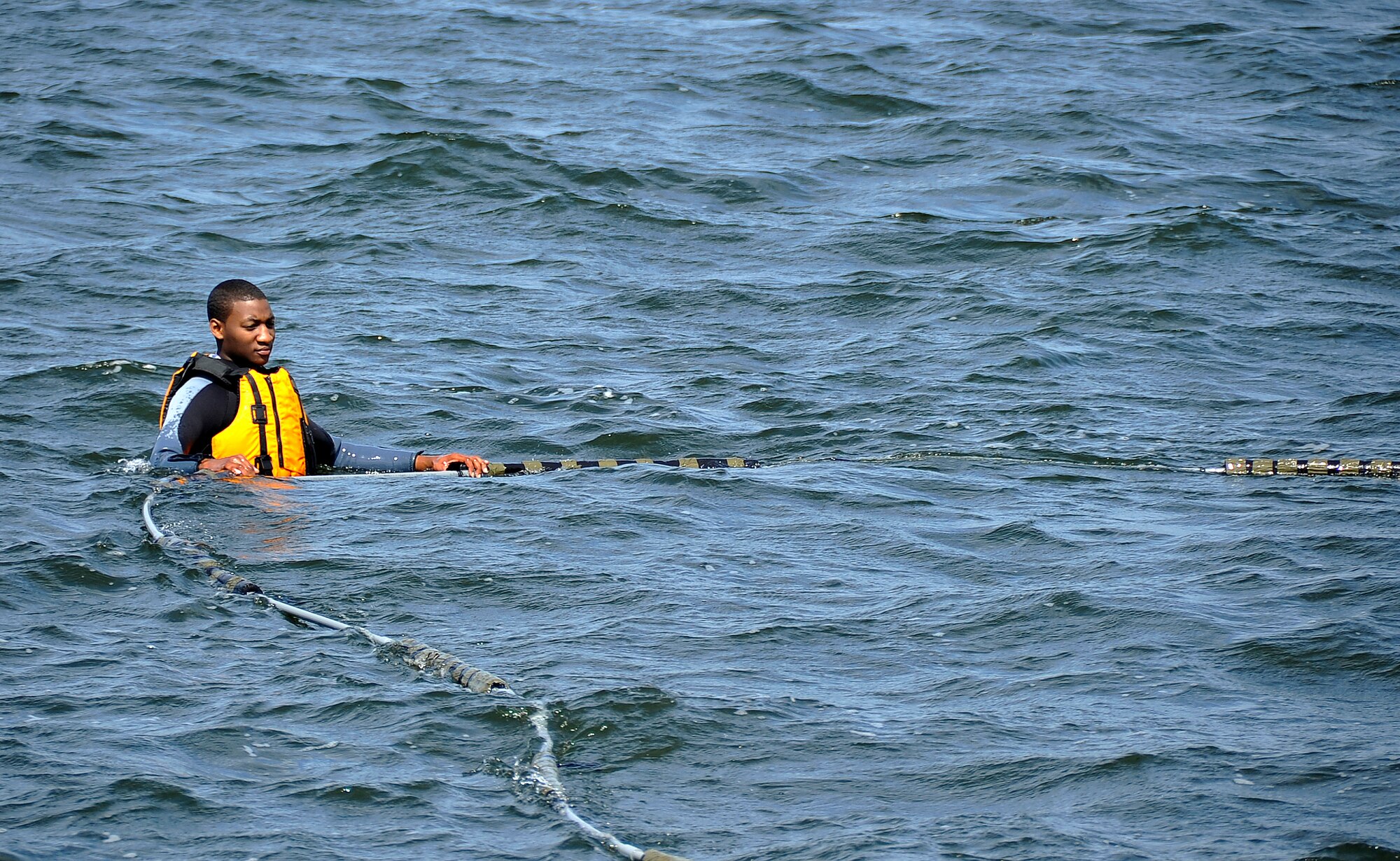 MISAWA AIR BASE, Japan -- Airman Desmond Jackson, 35th Operations Support Squadron, aircrew flight equipment technician, sets up the necessary equipment before water survival training at Lake Ogawara June 24, 2009.  Water survival training helps reacquaint aircrew with the skill to survive in case of an emergency.  (U.S. Air Force photo by Senior Airman Chad C. Strohmeyer)