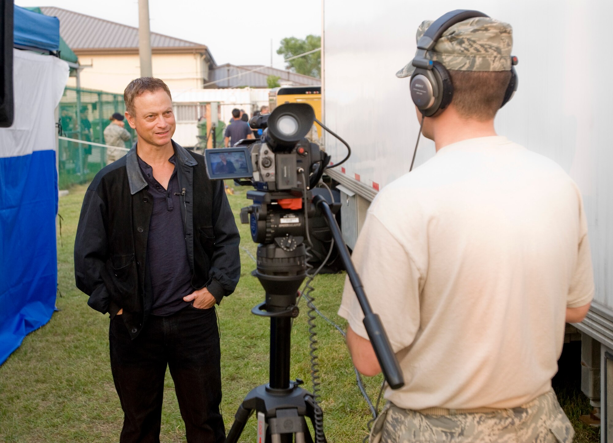 KUNSAN AIR BASE, Republic of Korea -- Gary Sinise, the bassist for Lt. Dan Band, gives an interview to Staff Sgt. Michael Schocker, Armed Forces Network Korea, about why he and his band do shows for the troops June 24. The Lt. Dan Band stopped at the Wolf Pack as part of their Asia USO tour. (U.S. Air Force photo by Senior Airman Jonathan Steffen)