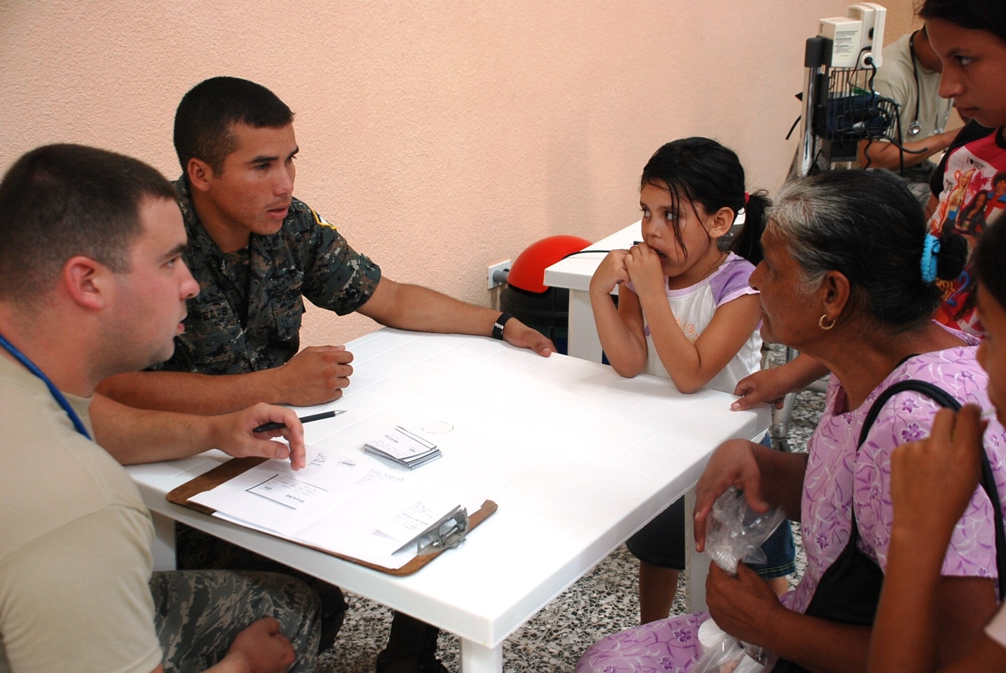 POPTUN, Guatemala -- U.S. Air Force Senior Airman Tony Jimenez and Guatemala Army Pvt. Josue Ibanez evaluate the condition of an elderly woman seeking care at a medical readiness and training exercise held at the Brazos de Amor community center here June 24. Twenty-three members of Joint Task Force-Bravo at Soto Cano Air Base, Honduras, teamed up with the Guatemalan Army, Guatemalan Military Group, and Guatemalan Ministry of Health to offer care to those without regular access to treatment. (U.S. Air Force photo/Tech. Sgt. Mike Hammond)