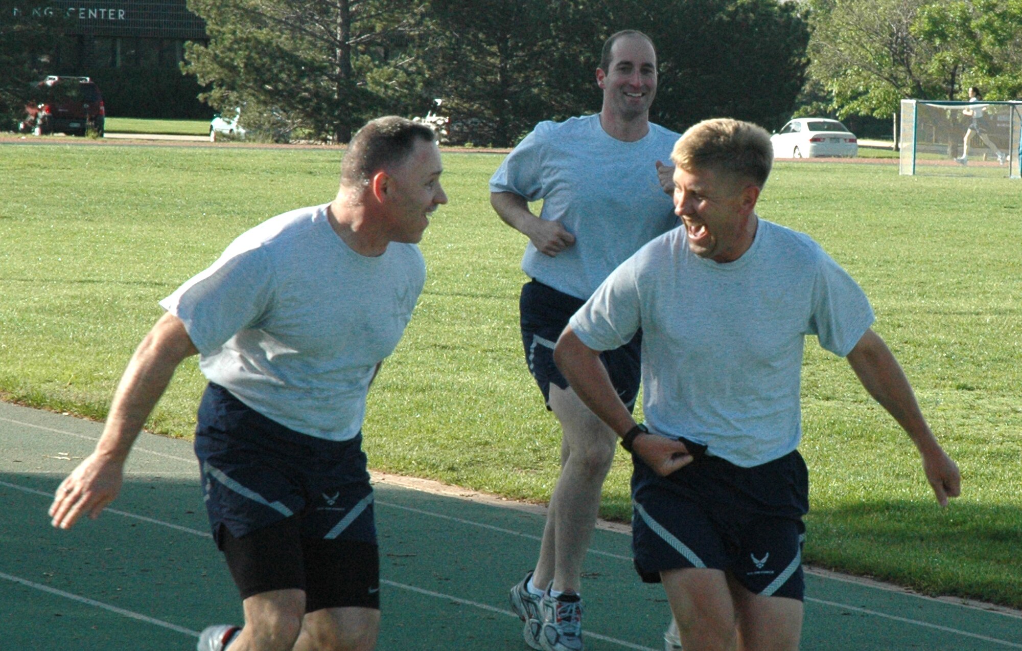 Maj. Alan Flolo, 302nd Airlift Wing executive officer (right), jokes with Chief Master Sgt. Rocky Hart during the June 14 'Get Fit with Leadership' run at the Peterson Air Force Base track in Colorado. Each Sunday during Unit Training Assemblies, or UTA weekends, members of the 302nd AW can come out to the base track and run with leadership. Members shoould report to the track no later than 7:30 a.m. Chief Hart is the 310th Space Wing command chief, based at local Schriever AFB. (U.S. Air Force photo/Tech. Sgt. Daniel Butterfield)