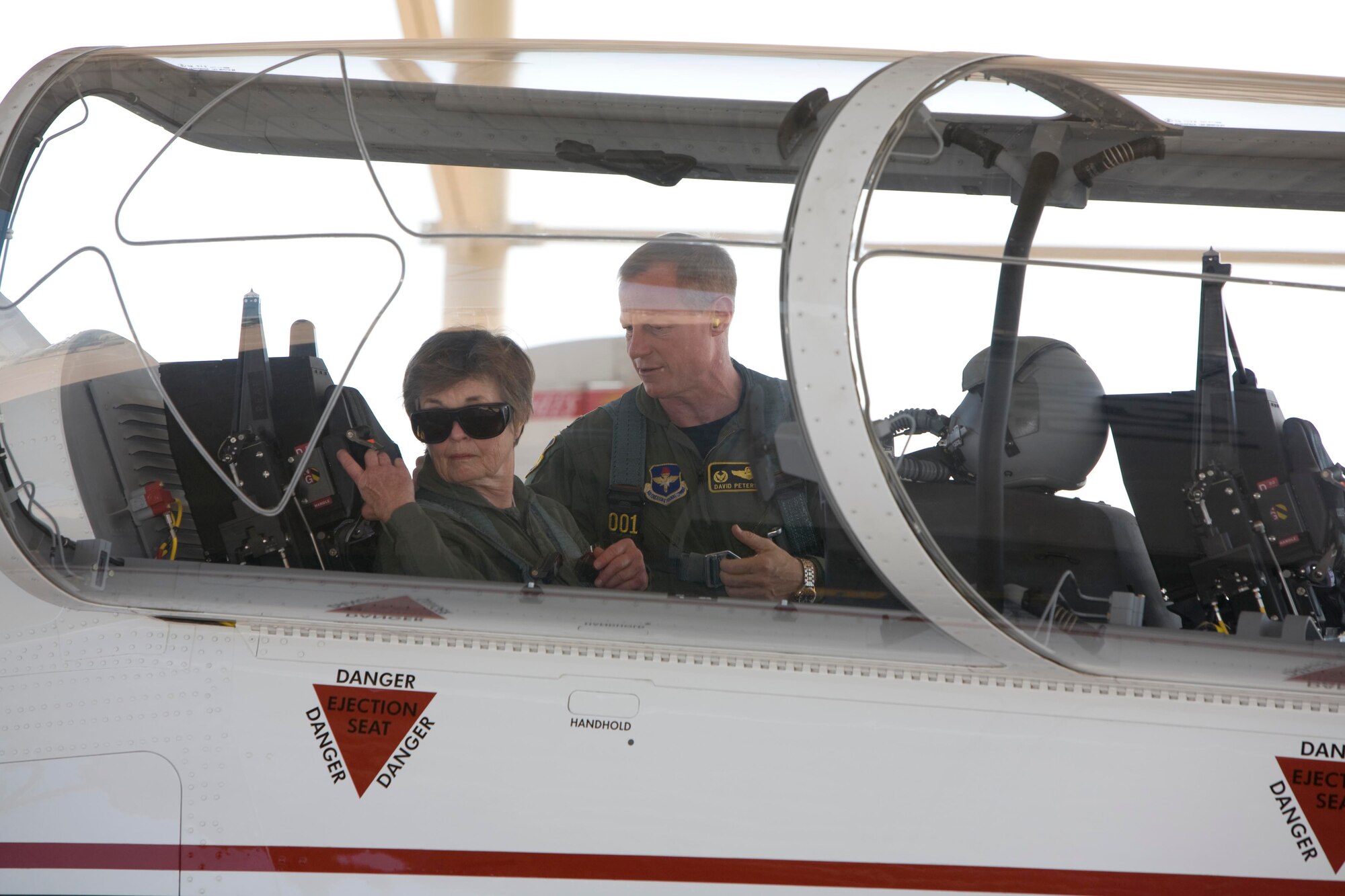 Col. David Petersen, 80th Flying Training Wing commander, helps former Wichita Falls Mayor Kay Yeager get strapped in June 24 prior to their T-6A Texan II flight. Sheppard hosted Mrs. Yeager to a public affairs flight due to her continued support of the base. Mrs. Yeager is also a member of the Chief of Staff of the Air Force Civic Commander's group. (U.S. Air Force photo/Lt. Col. Ternell Washington)