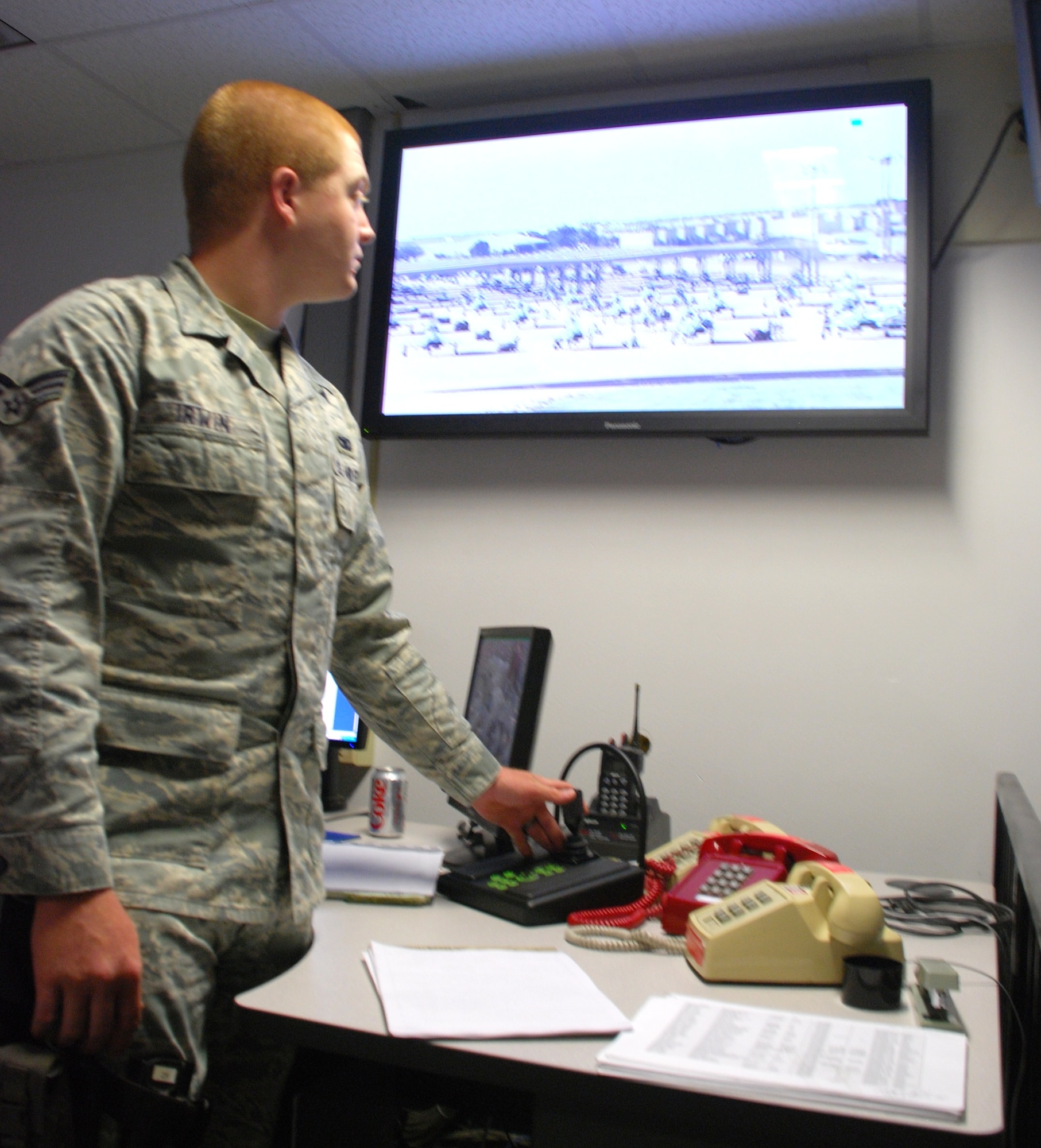 Senior Airman Jeffery Irwin 82nd Security Forces Squadron desk sergeant, controls the Wide Surveillance Thermal Imager located next to bldg. 2558, from the SFS building. From the SFS bldg. and observes the flight line and the air craft from, approximately one and a half miles away from the WSTI. (U.S. Air Force Photo/ Airman Adawn Kelsey)