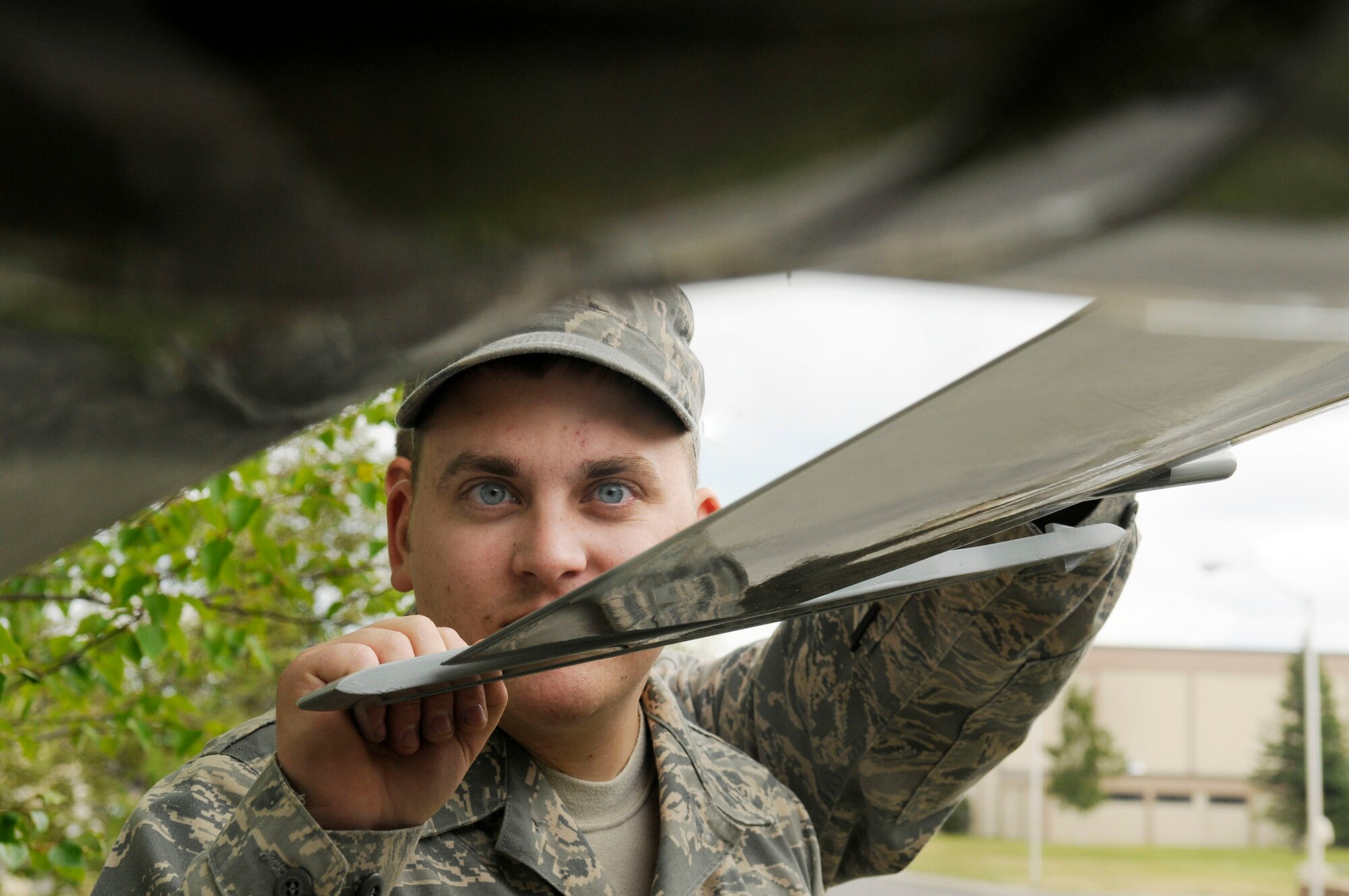 Senior Airman Jerod Bechard checks the stability of the model aircraft June 19, 2009, Eielson Air Force Base, Alaska. Airman Bechard was one of the Airmen who painted the model arctic camouflage to resemble the 18th Aggressor Squadron aircraft. Airman Bechard is assigned to the 354th Maintenance Squadron, Aircraft Structural Maintenance flight.  (U.S. Air Force photo/Airman 1st Class Laura Max)