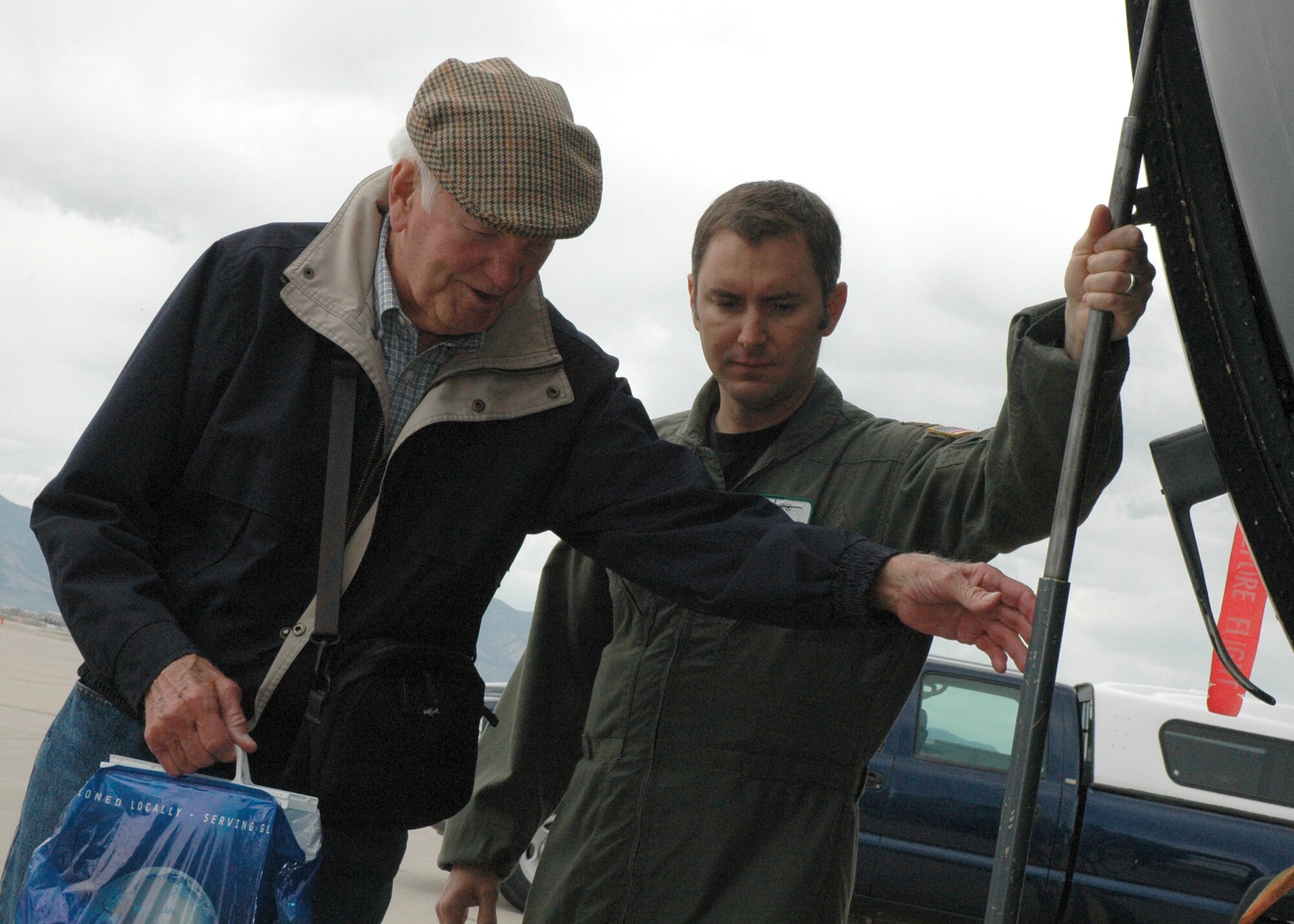 Maj. Jeff Phillips (right) escorts William "Bill" Hix Poole onto a 302nd Airlift Wing Air Force Reserve C-130 "Hercules" May 4 during a visit to Peterson Air Force Base, Colo. Mr. Poole, a B-25 bomber pilot assigned to the 310th Bombardment Group during World War II, was escorted throughout the base to get an up-close look at the mission of the 310th Space Wing and its subordinate units. Mr. Poole saw combat in the skies above both North Africa and Italy, and had flown 73 combat missions by the age of 20. The 310th SW, an AF Reserve wing, was reactivated recently, taking on the famed namesake of the 310th BW. Major Phillips is a pilot with the 731st Airlift Squadron. (U.S. Air Force photo/Senior Airman Stephen J. Collier)