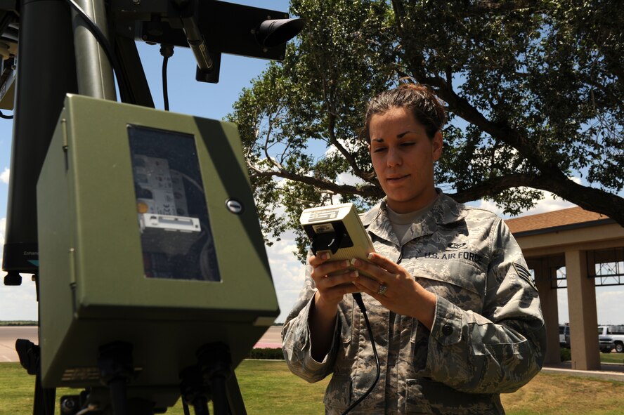 DYESS AIR FORCE BASE, Texas – Senior Airman Ann Winters, 7th Operations Support Squadron, uses a tactical weather system to determine the temperature, dew point, wind speed and barometric pressure June 24 on the flight line here. Airmen from the weather flight stay vigilant due to the severe weather season. The flight is required to get tornado warnings out to base members if severe activity is within five miles of base, to allow ample time for people to take proper safety precautions. (U.S. Air Force photo by Senior Airman Jennifer Romig)