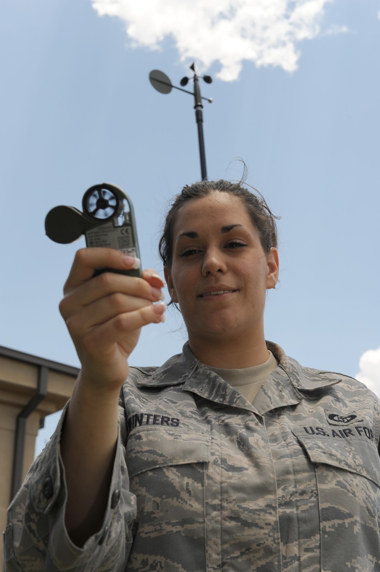 DYESS AIR FORCE BASE, Texas – Senior Airman Ann Winters, 7th Operations Support Squadron, uses a kestrel, a mobile weather device to determine the temperature, dew point, wind speed and barometric pressure June 24 on the flight line here. Airmen from the weather flight stay vigilant due to the severe weather season. The flight is required to get tornado warnings out to base members if severe activity is within five miles of base, to allow ample time for people to take proper safety precautions. (U.S. Air Force photo by Senior Airman Jennifer Romig)
