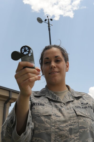 DYESS AIR FORCE BASE, Texas – Senior Airman Ann Winters, 7th Operations Support Squadron, uses a kestrel, a mobile weather device to determine the temperature, dew point, wind speed and barometric pressure June 24 on the flight line here. Airmen from the weather flight stay vigilant due to the severe weather season. The flight is required to get tornado warnings out to base members if severe activity is within five miles of base, to allow ample time for people to take proper safety precautions. (U.S. Air Force photo by Senior Airman Jennifer Romig)
