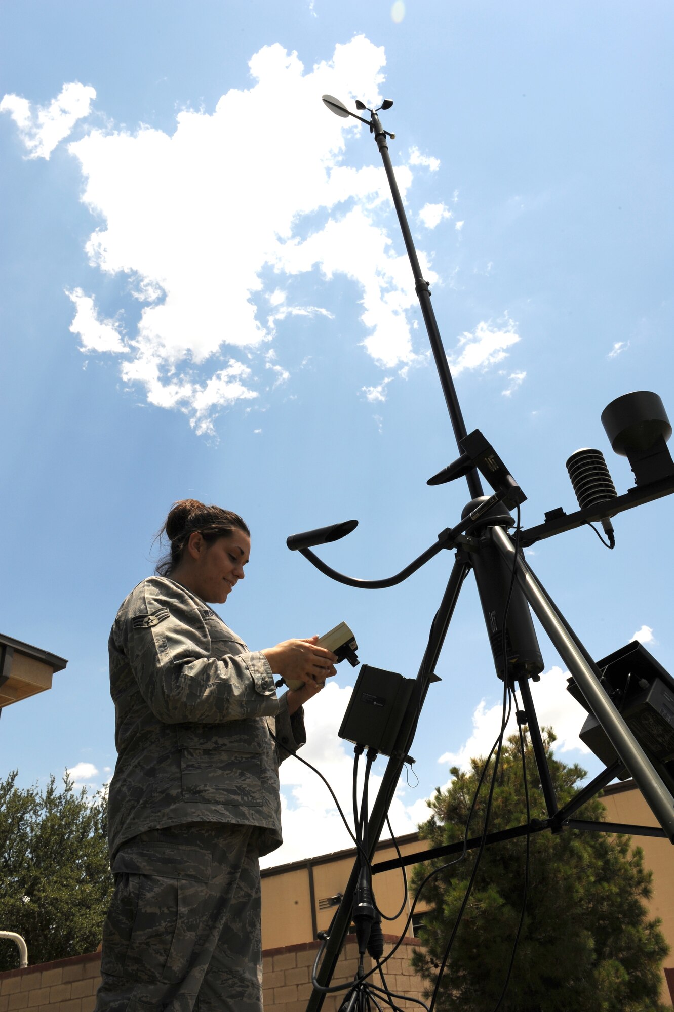 DYESS AIR FORCE BASE, Texas – Senior Airman Ann Winters, 7th Operations Support Squadron, uses tactical weather equipment June 24 on the flight line here to get a reading of the temperature, wind speed, dew point and barometric pressure. One of the weather flight’s responsibilities is to provide quick and accurate tornado and severe weather warnings to Dyess and its Airmen. (U.S. Air Force photo by Senior Airman Jennifer Romig)