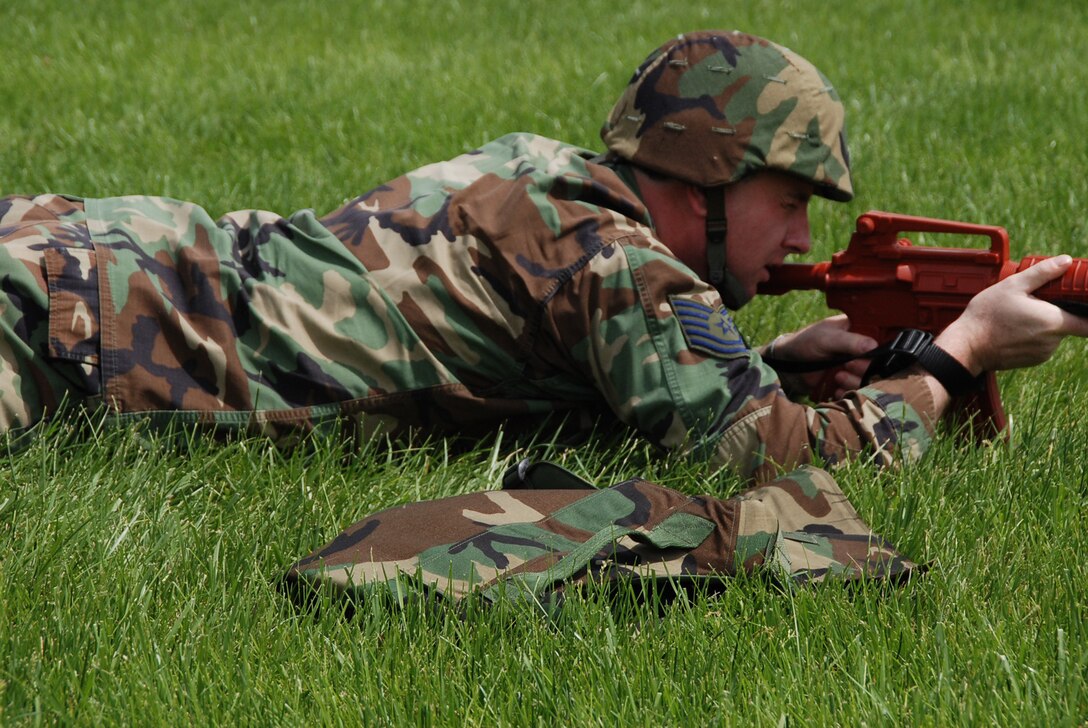 A civil engineer takes aim downrange as he stays low in the grass with a simulated M-16 rifle.  The wing comes together again each core weekend to learn mission essential tasks and to stay sharp physically and mentally.  (U.S. Air Force photo/Tech. Sgt. Dan Oliver)