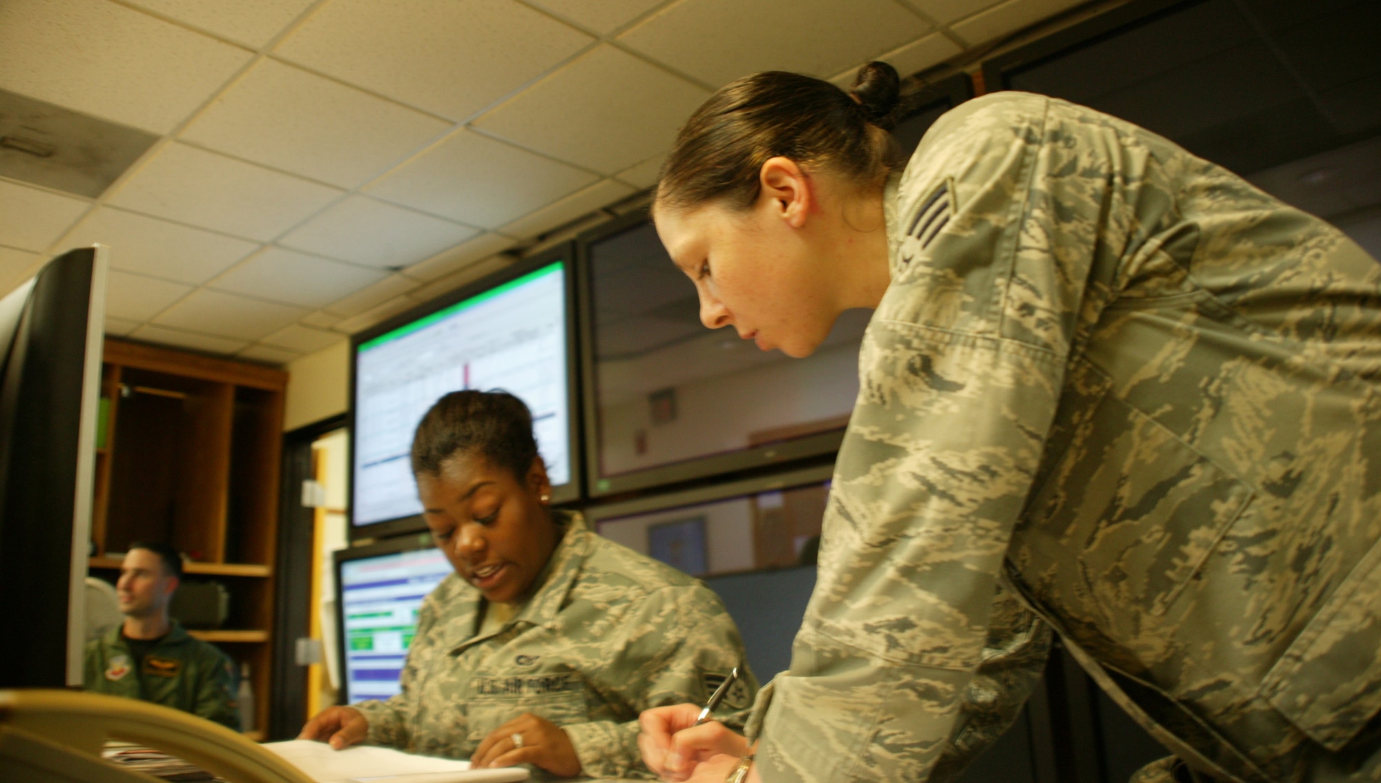 SHAW AIR FORCE BASE, S.C. -- Senior Airman Mary Wheeler records take-off and landing times from Senior Airman Trinece Purdie.  Senior Airman Wheeler received the only coin from the inspector general during Shaw's 2009 Operational Readiness Inspection. (U.S. Air Force photo/Tech. Sgt. Vincent Mouzon)