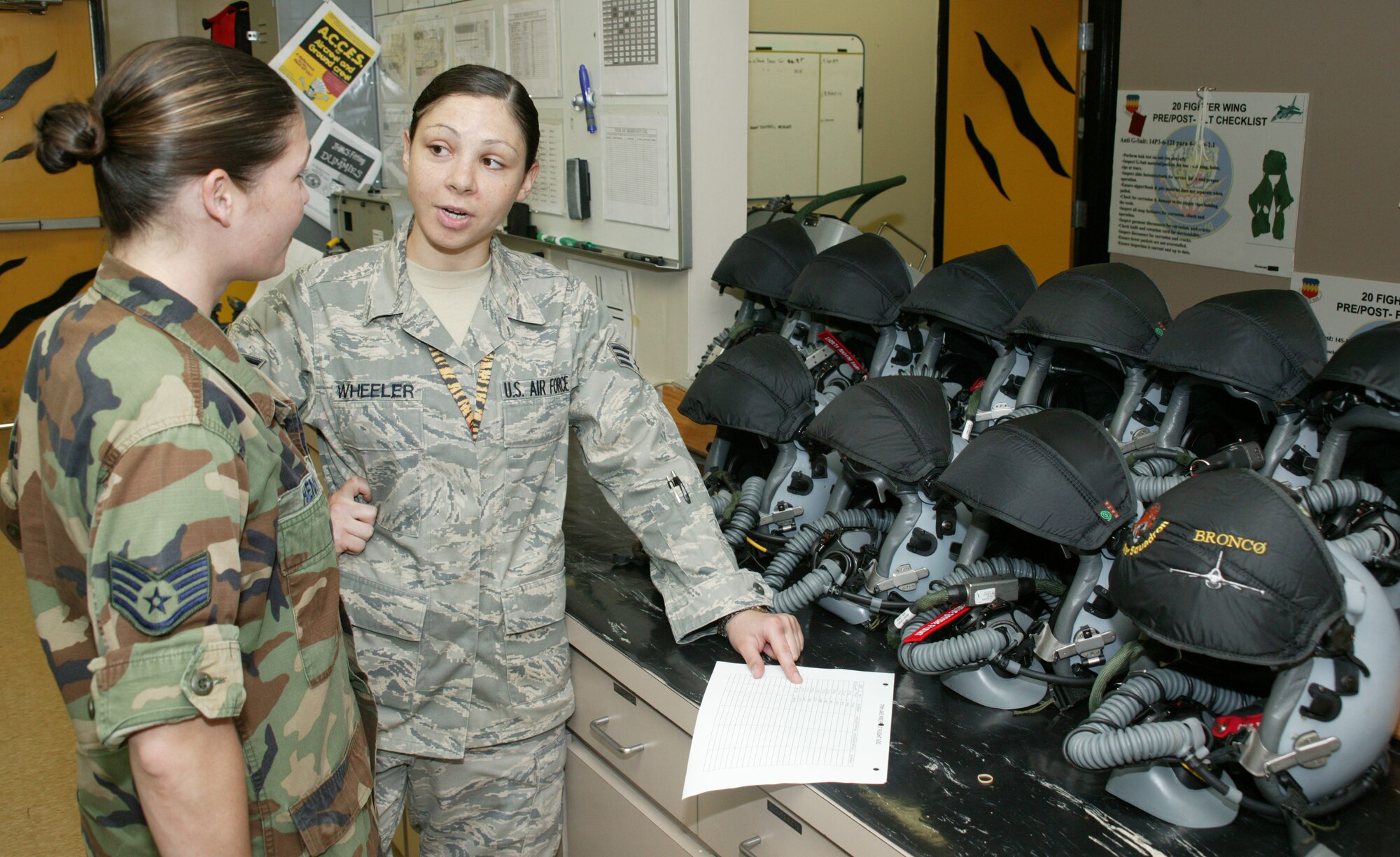 SHAW AIR FORCE BASE, S.C. -- Senior Airman Mary Wheeler and Staff Sgt. Lori Henry, 79th Fighter Squadron, verify information for fighter pilot evasion plans of action. Airman Wheeler received the only coin from the inspector general during Shaw's 2009 Operational Readiness Inspection. (U.S. Air Force photo/Tech. Sgt. Vincent Mouzon)