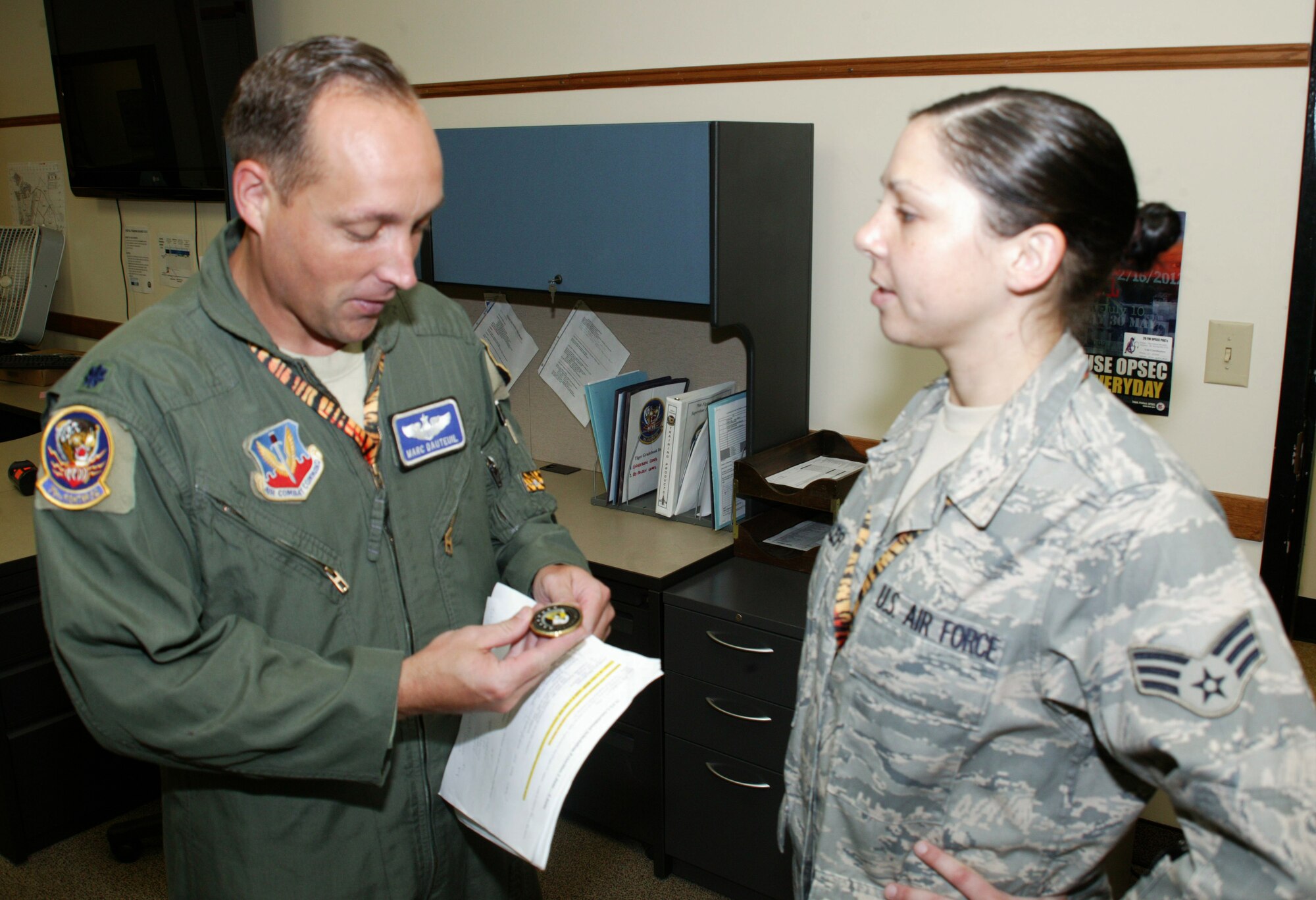 SHAW AIR FORCE BASE, S.C. -- Lieutenant Col. Marc Dauteuil, 79th Fighter Squadron director of operations, checks out Senior Airman Wheeler's inspector general coin. Airman Wheeler received the only coin from the IG during Shaw's 2009 Operational Readiness Inspection. (U.S. Air Force photo/Tech. Sgt. Vincent Mouzon)