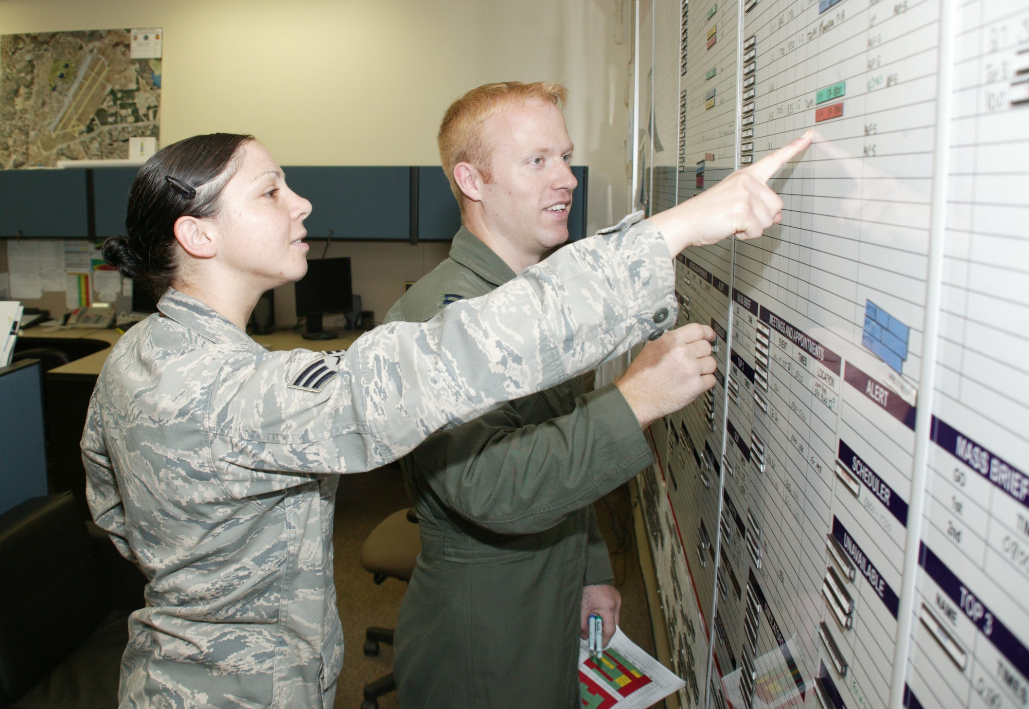 SHAW AIR FORCE BASE, S.C. -- Senior Airman Mary Wheeler and Capt. Brad Matherne update the daily schedule board for the 79th Fighter Squadron. Airman Wheeler  received the only coin from the inspector general during Shaw's 2009 Operational Readiness Inspection. (U.S. Air Force photo/Tech. Sgt.Vincent Mouzon)