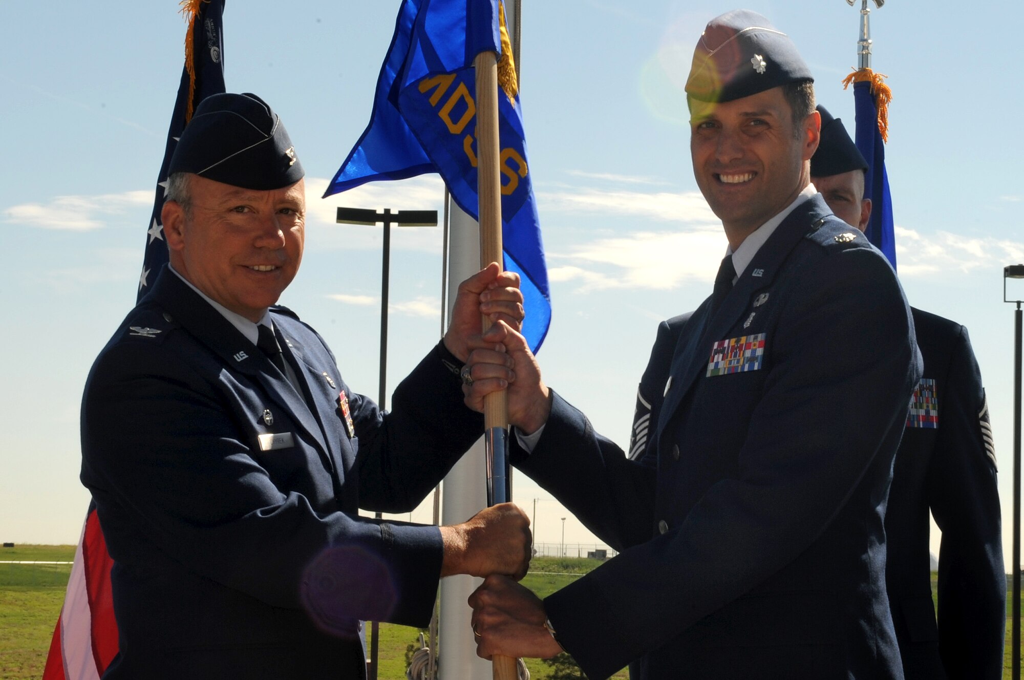 BUCKLEY AIR FORCE BASE, Colo. – Col. Michael Chyrek , 460th Medical Group commander, hands over  command of the 460th Medical Support Squadron to Lt. Col. Scot Spann, in a change of command ceremony outside the 460th Space Wing headquarters building, June 17.  Colonel Spann assumed command from Col. Kirsten Watkins and joins Team Buckley from Wright-Patterson AFB, Ohio.  (U.S. Air Force photo by Senior Airman Erika Brooke) 