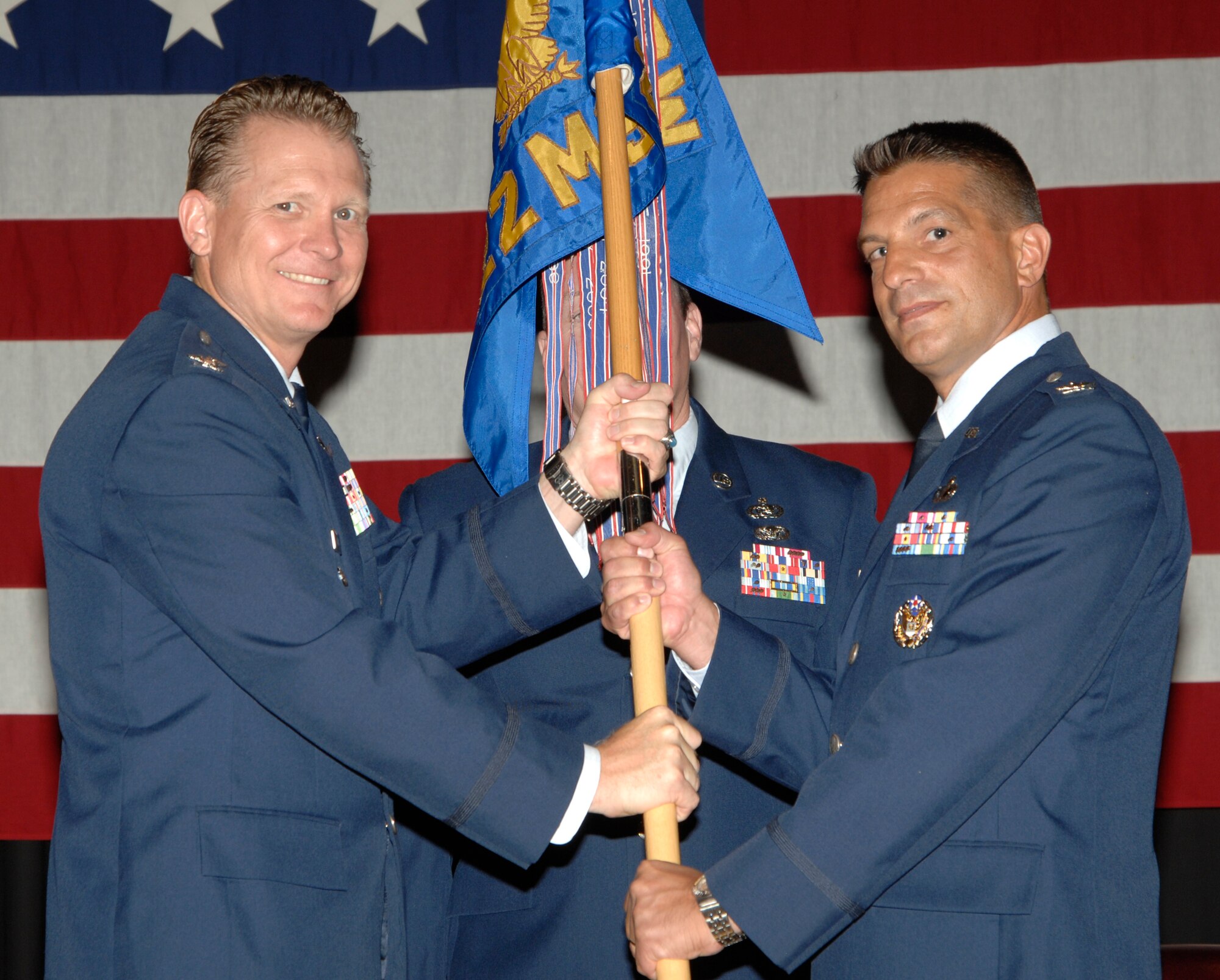 MCCONNELL AIR FORCE BASE, Kan. – Col. Bart Weiss, 22nd Air Refueling Wing vice commander, passes the guidon to Col. Pat Rose, incoming 22nd Mission Support Group commander, during the change of command ceremony at the Robert J. Dole Community Center ballroom, June 23. Colonel Rose assumed command over the Mission Support Group from Col. Mark White. (Photo by Senior Airman Laura Suttles)