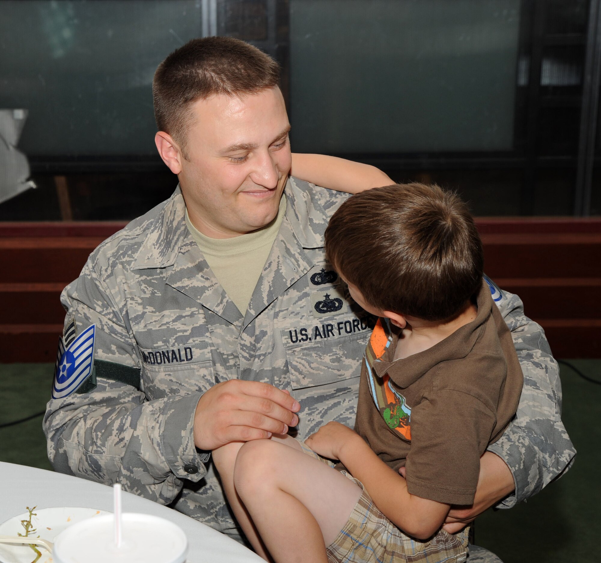 MCCONNELL AIR FORCE BASE, Kan.-- Staff Sgt. Terry McDonald, 22nd Communications Squadron, and son Trenton, 5, celebrate during the Technical Sergeant Selects’ Promotion Party at Signatures, June 18. The party is for the 38 Team McConnell Staff Sergeants who were selected to be promoted to Technical Sergeant, including Sergeant McDonald. (Photo by Senior Airman Roy Lynch) 