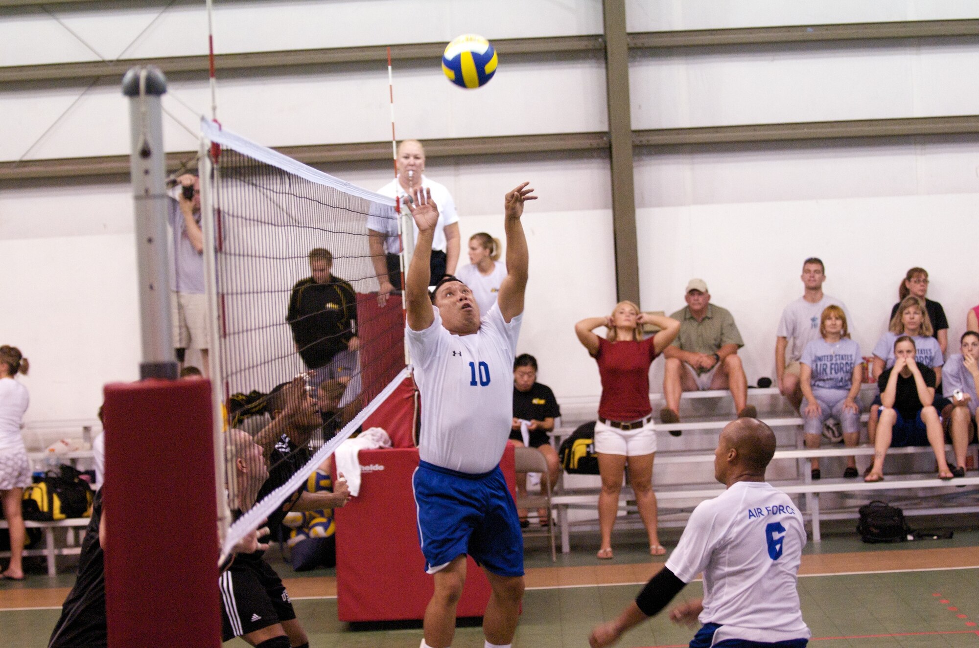Arizona Air National Guardsman Staff Sgt. Ray Valles sets the ball for Staff Sgt. Clarence Hucks from Yakota Air Base, Japan, at the Armed Forces Volleyball Championship at Marine Corps Air Station Cherry Point, N.C. The Air Force’s men’s team won first place during championship finals, June 10. (Courtesy photo by Kavika Lacar)