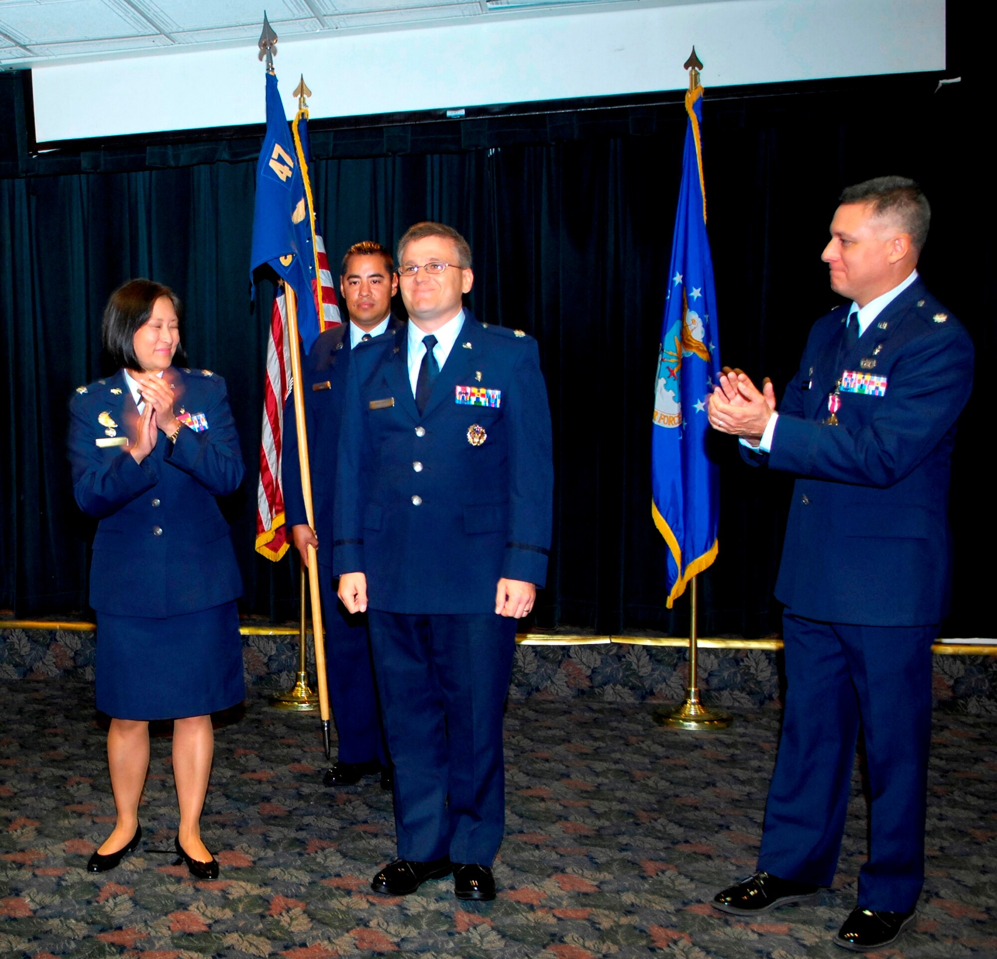LAUGHLIN AIR FORCE BASE, Texas--Lt. Col. Kirk Phillips, 47th Medical Support Squadron commander, is recognized as the new commander of the squadron as Colonel Lawra Lee, 47th Medical Group commander, and Lt. Col. Joseph Aigner-Varoz, former 47th MDSS commander, applaud June 22.  Colonel Phillips came from the Air Force Medical Support Agency in Bolling Air Force Base, D.C., where he served as the bioenvironmental engineering force development chief. (U.S. Air Force photo by Paco Mendoza) 