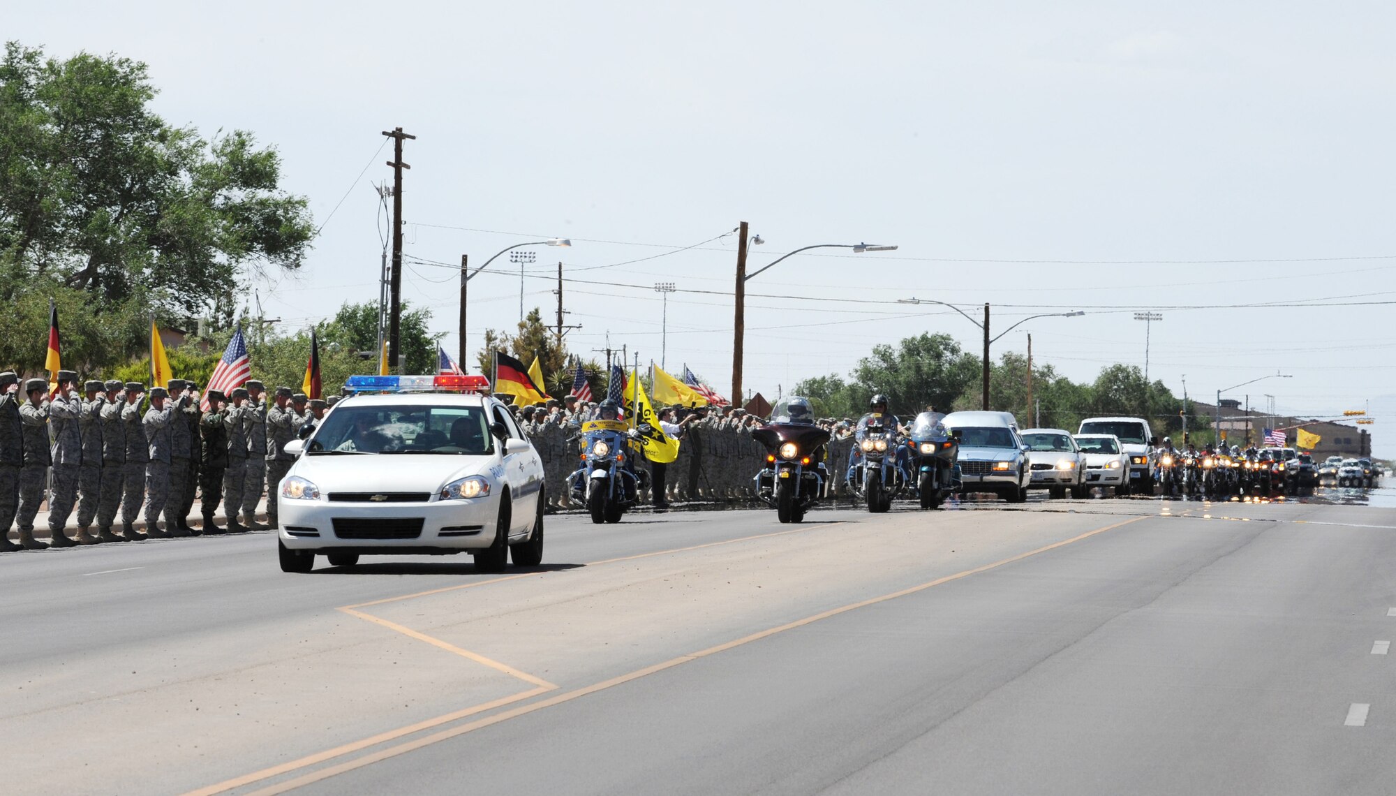Holloman Air Force Base members render a final salute to Army Spc. Christopher Kurth June 11 at Holloman Air Force Base, N.M., The Soldier was killed in a grenade attack June 4 near Kirkuk, Iraq. Specialist Kurth was a native of Alamogordo, N.M., and was stationed at Fort Hood, Texas. (U.S. Air Force photo/Airman 1st Class Sondra Escutia)