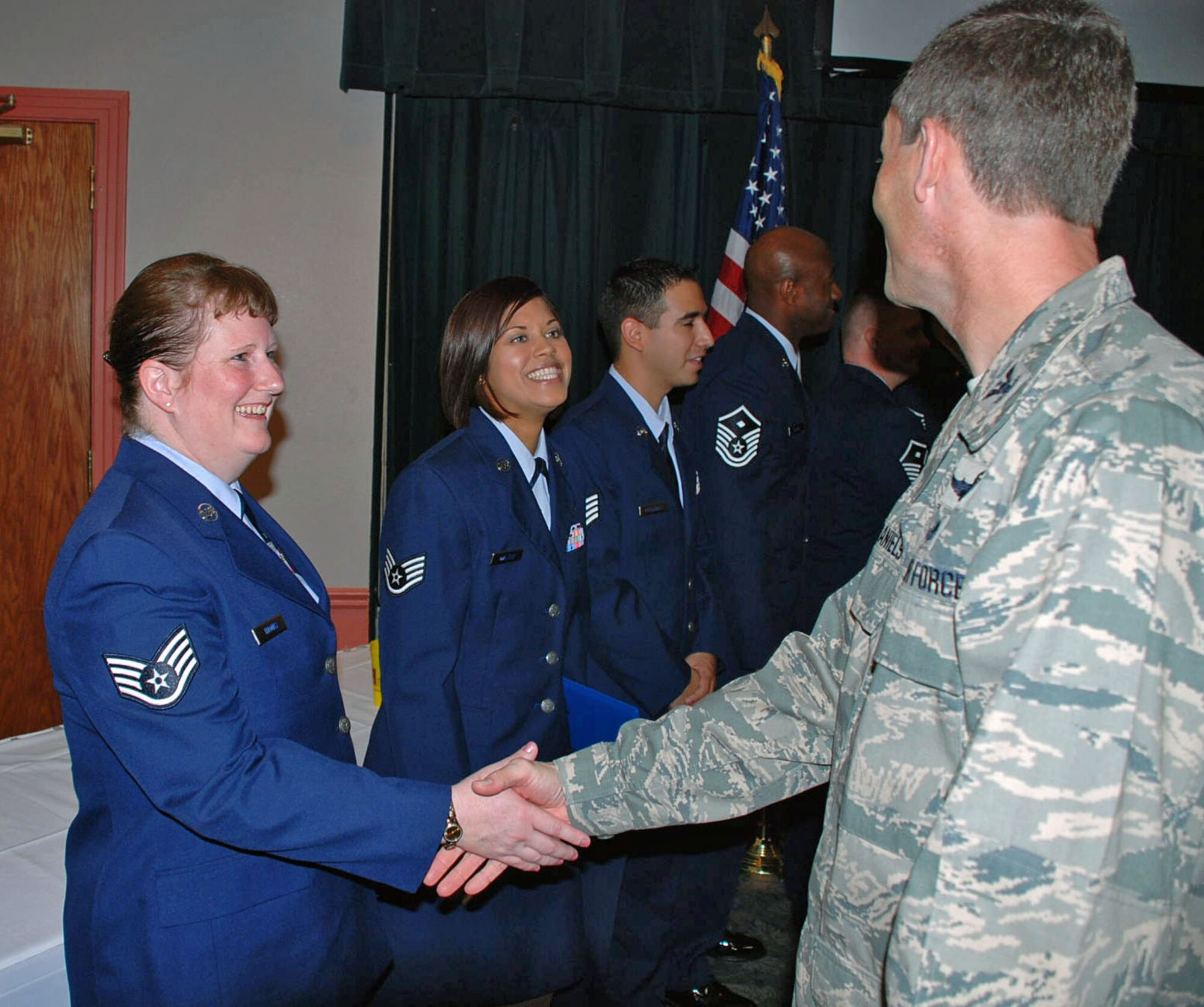 LAUGHLIN AIR FORCE BASE, Texas -- Col. Jeffrey McDaniels, 47th Flying Training Wing commander, congratulates Staff Sgt. Ronda Thomas, 47th Force Support Squadron base training manager, who graduated with an associate’s degree from the Community College of The Air Force here June 16. There were 23 Laughlin personnel who received various degrees from associate’s to master’s level programs. (U.S. Air Force photo by 2nd Lt. Tabish Khan)
