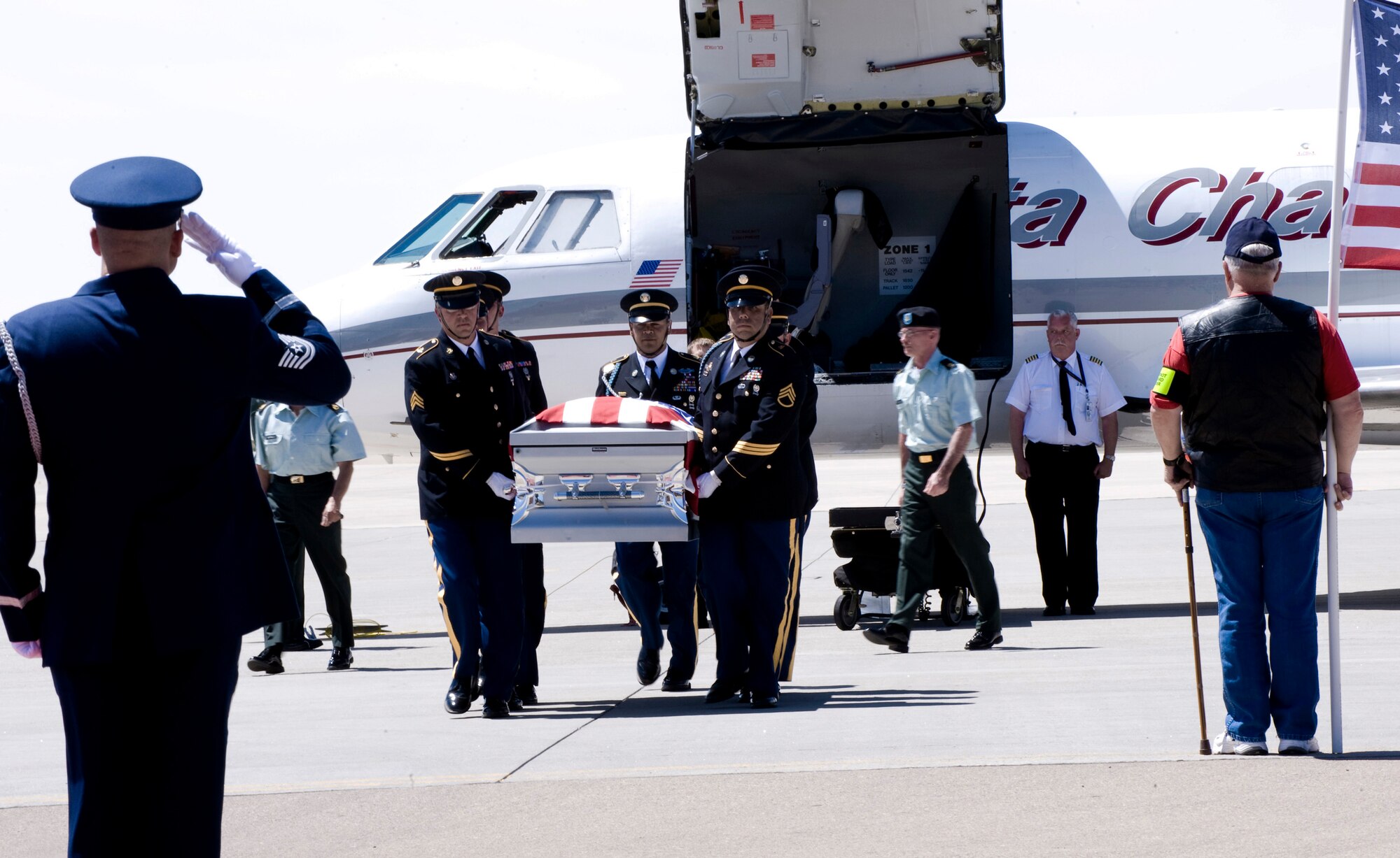 Members of the Patriot Guard Riders and Holloman Air Force Base honor guard pay their respects to the casket of Army Spec. Christopher M. Kurth as he is brought back June 11 for a burial in Alamogordo, N.M. The Soldier was killed in a grenade attack June 4 near Kirkuk, Iraq. Specialist Kurth was a native of Alamogordo, N.M., and was stationed at Fort Hood, Texas. (U.S. Air Force photo/Tech. Sgt. Alan Port) 
