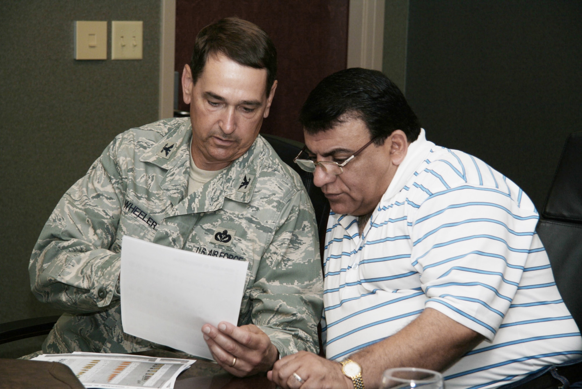 Col. Richard Wheeler talks with Iraqi Maj. Gen. Adbullah N. Nezar June 10 at Langley Air Force Base, Va. Colonel Wheeler is the installations and mission support deputy director. General Nezar is the ministry of interior infrastructure director in Iraq. (U.S. Air Force photo) 