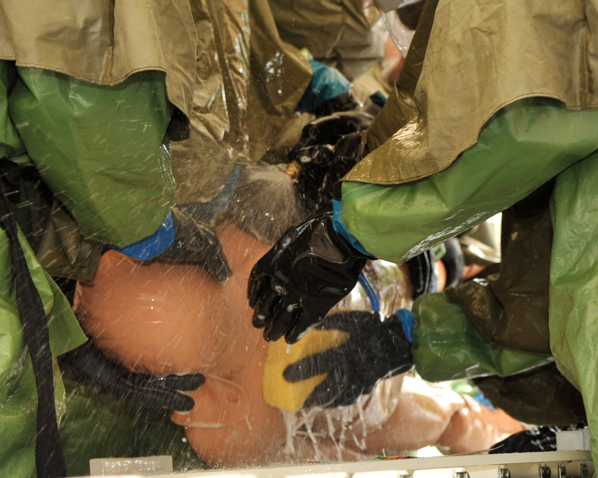SCOTT AIR FORCE BASE, Ill. -- Members of the 375th Medical Group practice decontaminating a fake patient June 18 at Scott.(U.S. Air Force photo/ Senior Airman Teresa Hawkins)