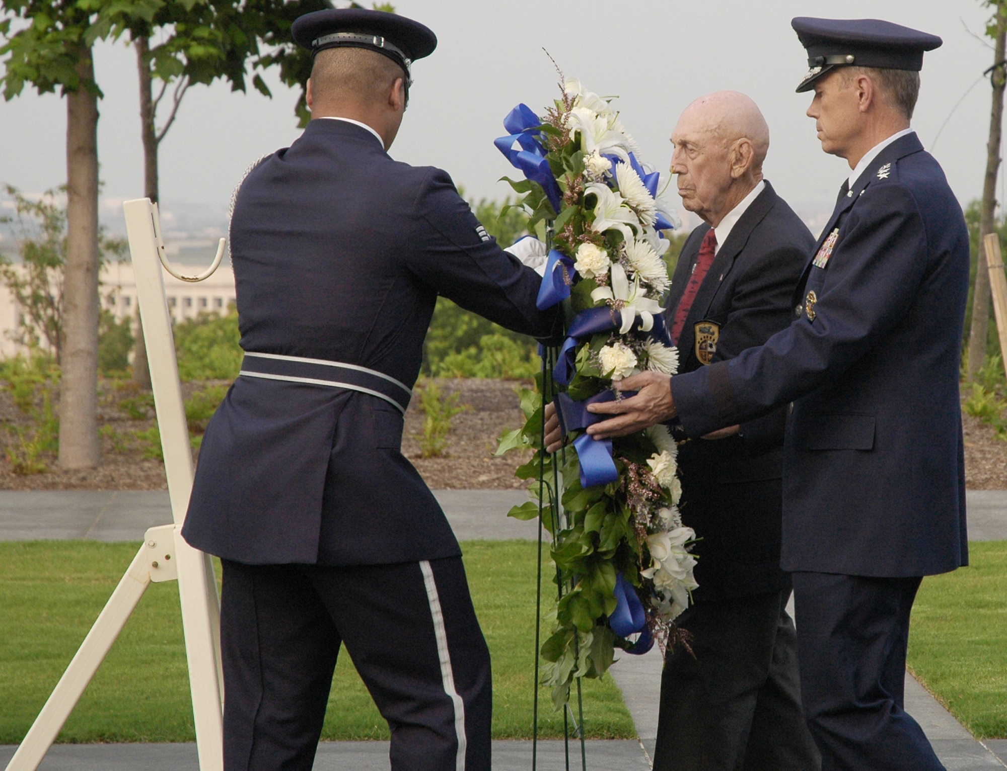 Air Force Vice Chief of Staff Gen. William M. Fraser III and surviving Doolittle Raider Richard Cole are assisted by an Air Force Honor Guard member during a wreath-laying ceremony June 19 at the U.S. Air Force Memorial in Arlington, Va. The wreath was laid near the Missing Man Wall to honor Maj. Gen. David Jones, a former Doolittle Raider and prisoner of war, who was buried at Arlington National Cemetery earlier that day. (U.S. Air Force photo/Senior Airman R. Michael Longoria)

