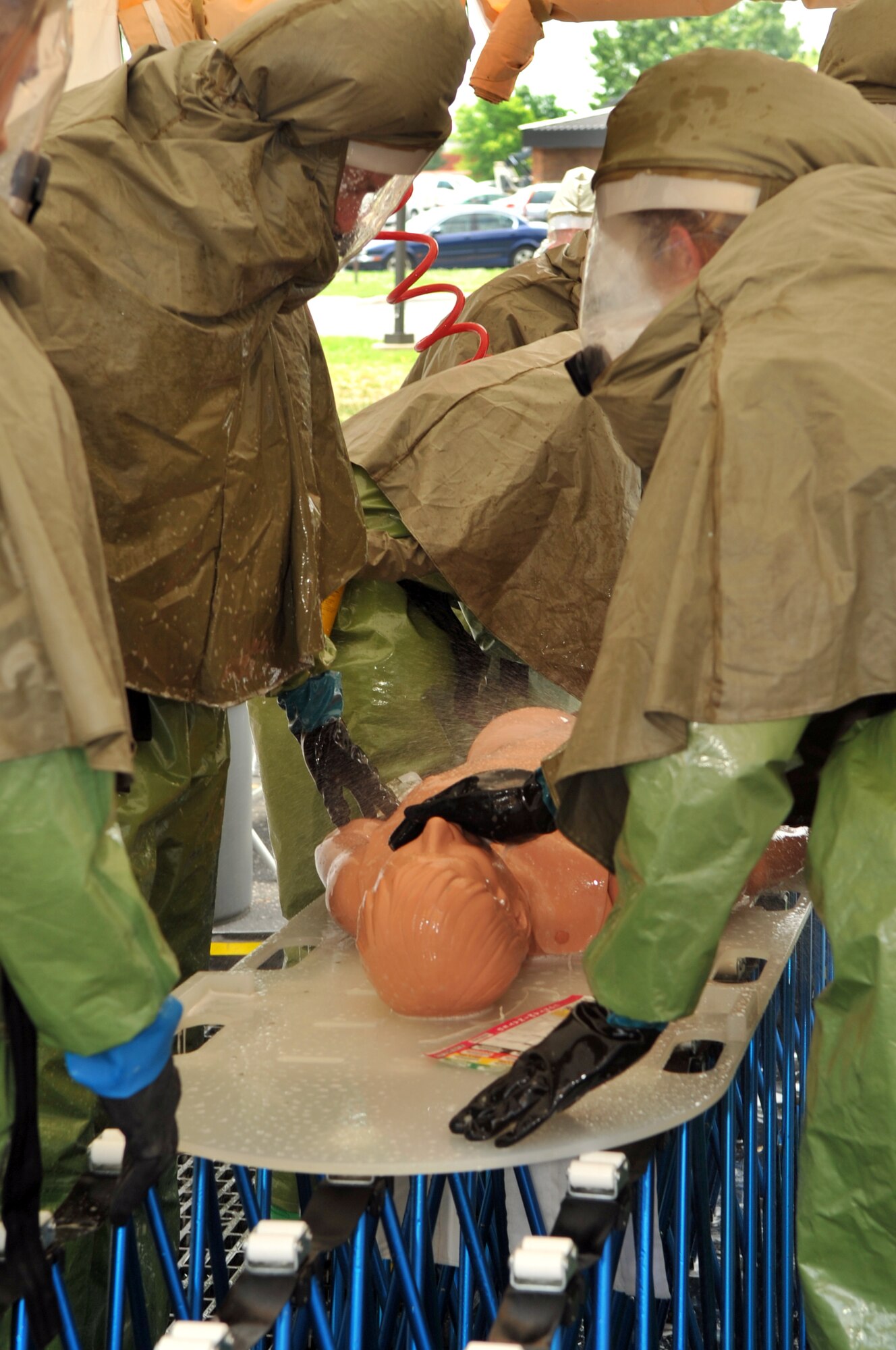 SCOTT AIR FORCE BASE, Ill. -- The 375th Medical Group core decontamination team takes a simulated litter patient through a decontamination line. Twenty-nine Airmen from across the 375th MDG went through a two day class taught by civilian contractors, Battelle, to learn in-place patient decontamination. (U.S. Air Force photo/ Senior Airman Teresa Hawkins)