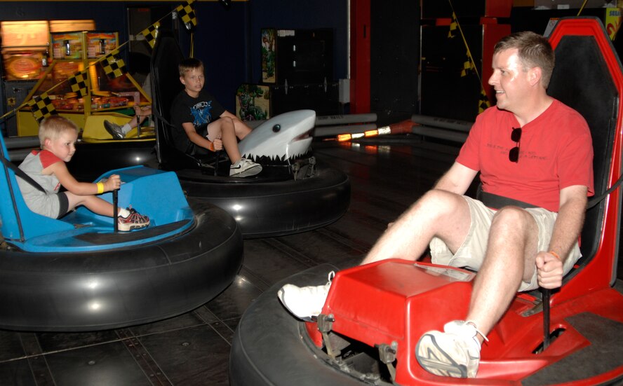 MCCONNELL AIR FORCE BASE, Kan. -- Team McConnell members engage in a game of bumper tag at All Star Adventures, June 19. All Star Adventures offers many different attractions including miniature golf, carnival rides, coin operated games, batting cages, and go-kart riding. (Photo by Senior Airman Laura Suttles)