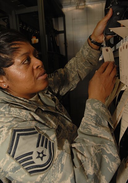 KIRKUK REGIONAL AIR BASE, Iraq – Senior Master Sgt. Pamela Rathers, 506th Expeditionary Logistics Readiness Squadron chief of supply, validates weapon prepositioning inventory June 19. Sergeant Rathers, a Fort Worth, Texas native, deployed from the 22nd LRS, McConnell AFB, Kan., is also serving as the squadron’s first sergeant during her deployment. (Photo by Senior Airman Jessica Lockoski)