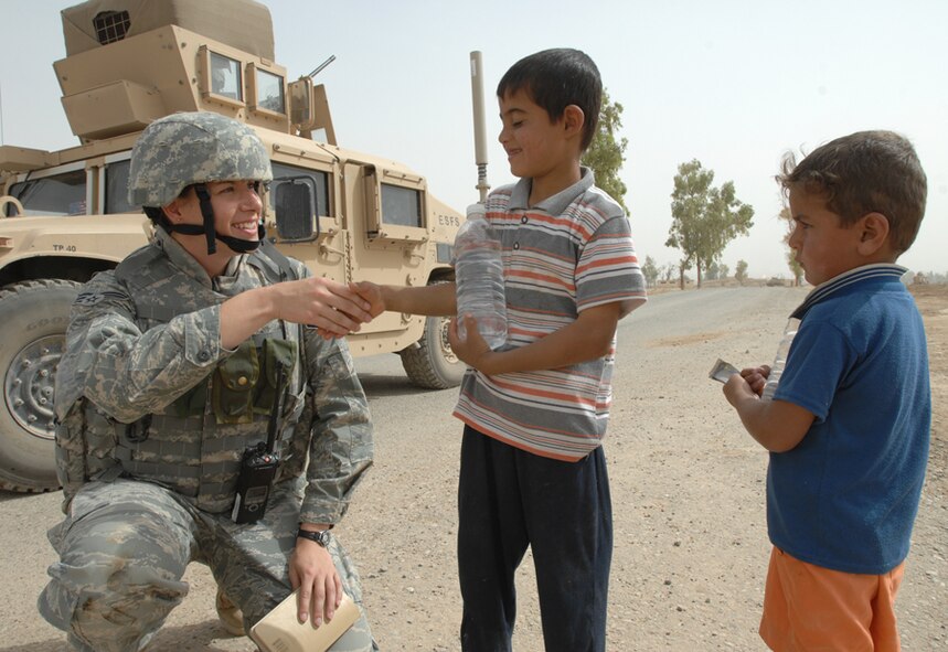 KIRKUK REGIONAL AIR BASE, Iraq – Senior Airman Jessica Lockoski, 506th Air Expeditionary Group Public Affairs, makes acquaintances with Kurdish children off base. The public affairs specialist, a Pittsburgh, Pa. native, is deployed from the 22nd Air Refueling Wing, McConnell AFB, Kan. (Photo by Staff Sgt. Eunique Stevens)