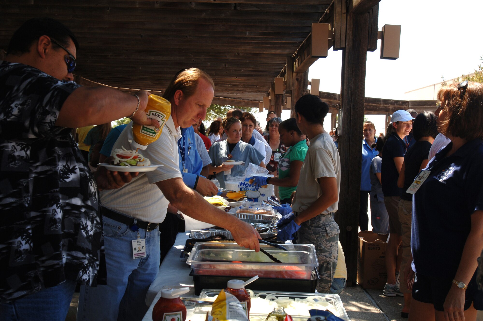 Personnel from the 59th Medical Wing gathered to celebrate months of hard work at the post Unit Compliance Inspection Burger Burn June 24 at Wilford Hall Medical Center, Lackland Air Force Base, Texas. The 59th MDW received an overall rating of "excellent" for the UCI.  (Air Force photo by Senior Airman Nicole Roberts) 