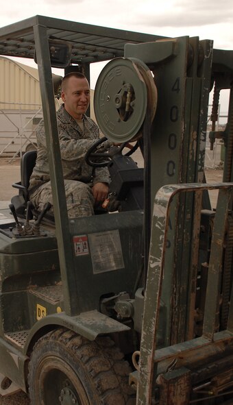 KIRKUK REGIONAL AIR BASE, Iraq – Staff Sgt. Paul Brueggeman, 506th Expeditionary Logistics Readiness Squadron, operates a fork lift in the vehicle maintenance compound in April.  The Rockford, Ill. native is deployed from McConnell AFB, Kan. (Photo by Senior Airman Jessica Lockoski) 