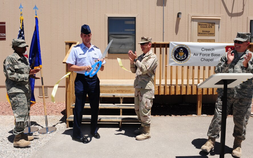 CREECH AFB Nev. -- Colonel Pete Gersten (left) 432d Wing and 432d Air Expeditionary Wing commander, and Chaplain (Maj.) David Kelley, 432d WG and 432d AEW Chaplain, officially open the Airmen Ministry Center with a ribbon cutting ceremony here June 22. (U.S. Air Force photo/Senior Airman William Coleman)