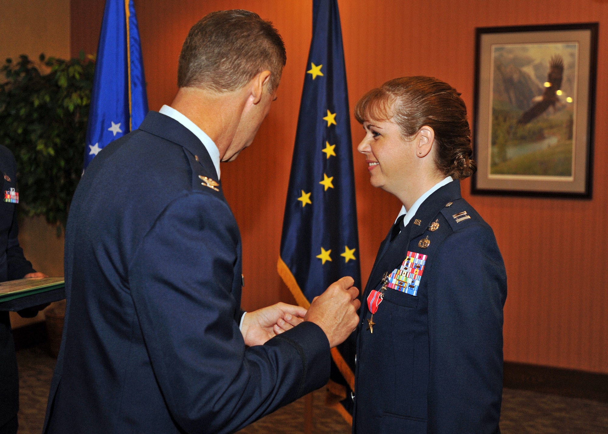 ELMENDORF AIR FORCE BASE, Alaska -- Capt. Karen Rupp is presented with a Bronze Star Medal from Col. Rich McClain during a ceremony here June 22. Rupp was awarded the medal for her service as commander of the 424th Medium Truck Detachment in support of Operation Iraqi Freedom. McClain is the 515th Air Mobility Operations Wing commander at Hickam Air Force Base, Hawaii. (U.S. Air Force photo/Senior Airman Laura Turner)