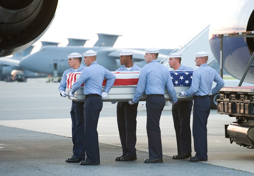 A Navy carry team transfers the remains of Navy Command Master Chief Jeffrey Garber, of Hemingford, Neb., at Dover Air Force Base, Del., June 23. He was the command master chief of Carrier Air Wing (CVW) 7. (U.S. Air Force photo/Jason Minto)
