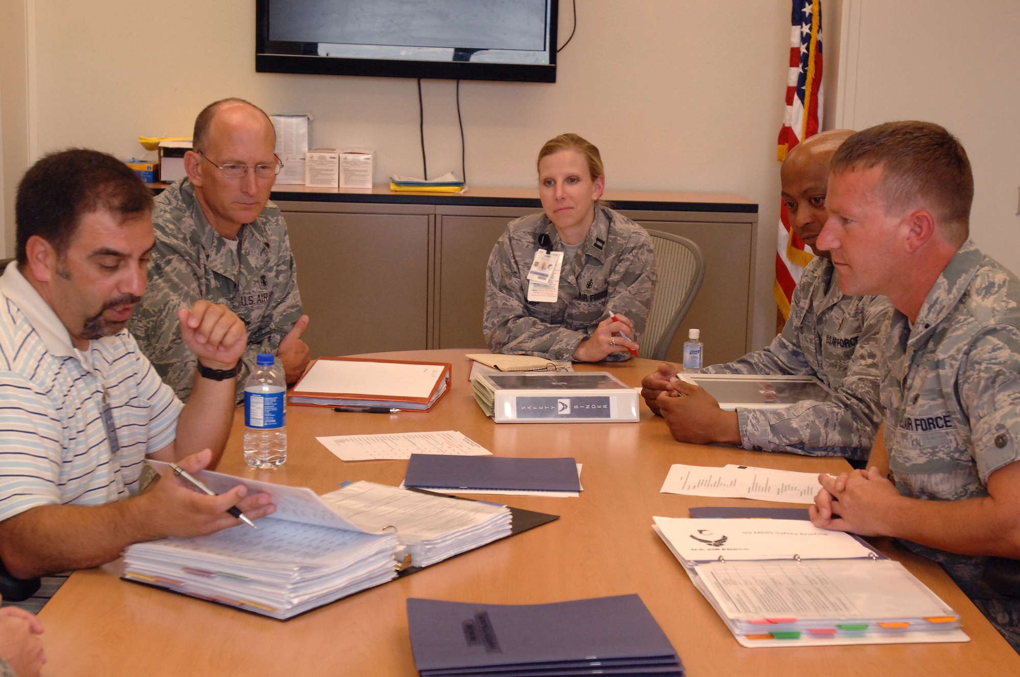 Mr. Paul Gomez, Inspector General, AETC Safety (left), reviews the 59th Medical Wing's Inpatient Squadron's safety program during the Unit Compliance Inspection June 17 at Wilford Hall Medical Center, Lackland Air Force Base, Texas.  (Air Force photo by Senior Airman Nicole Roberts)  