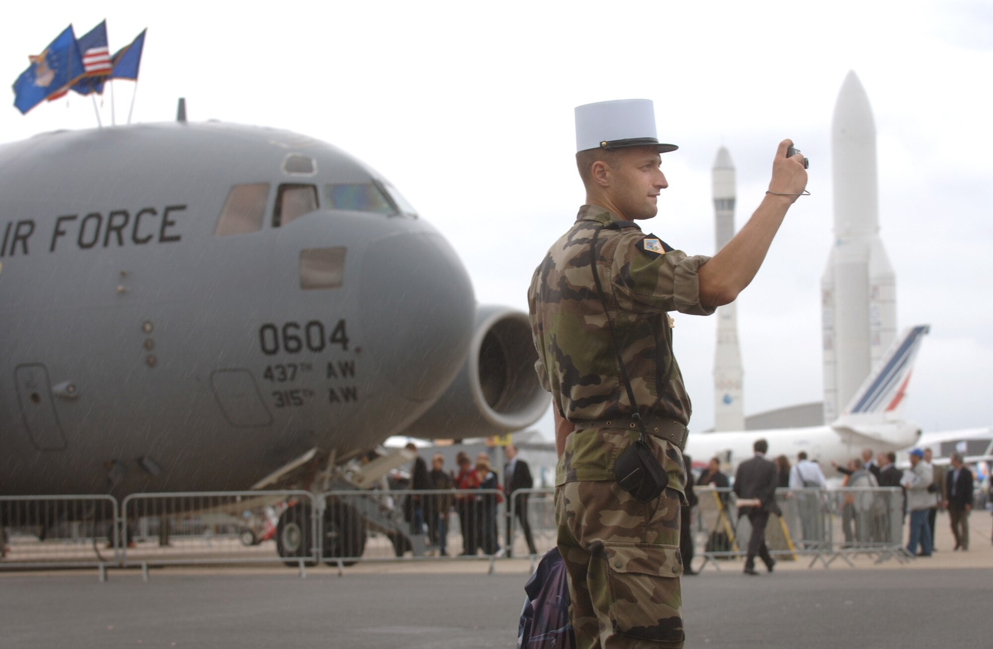 A Ukranian man assigned to the French Foreign Legion takes in the sites of the 2009 Paris Air Show June 18 at Le Bourget, France. The C-17 Globemaster III at left flew out of Charleston Air Force Base, S.C. (Defense Department photo/Master Sgt. Scott Wagers)