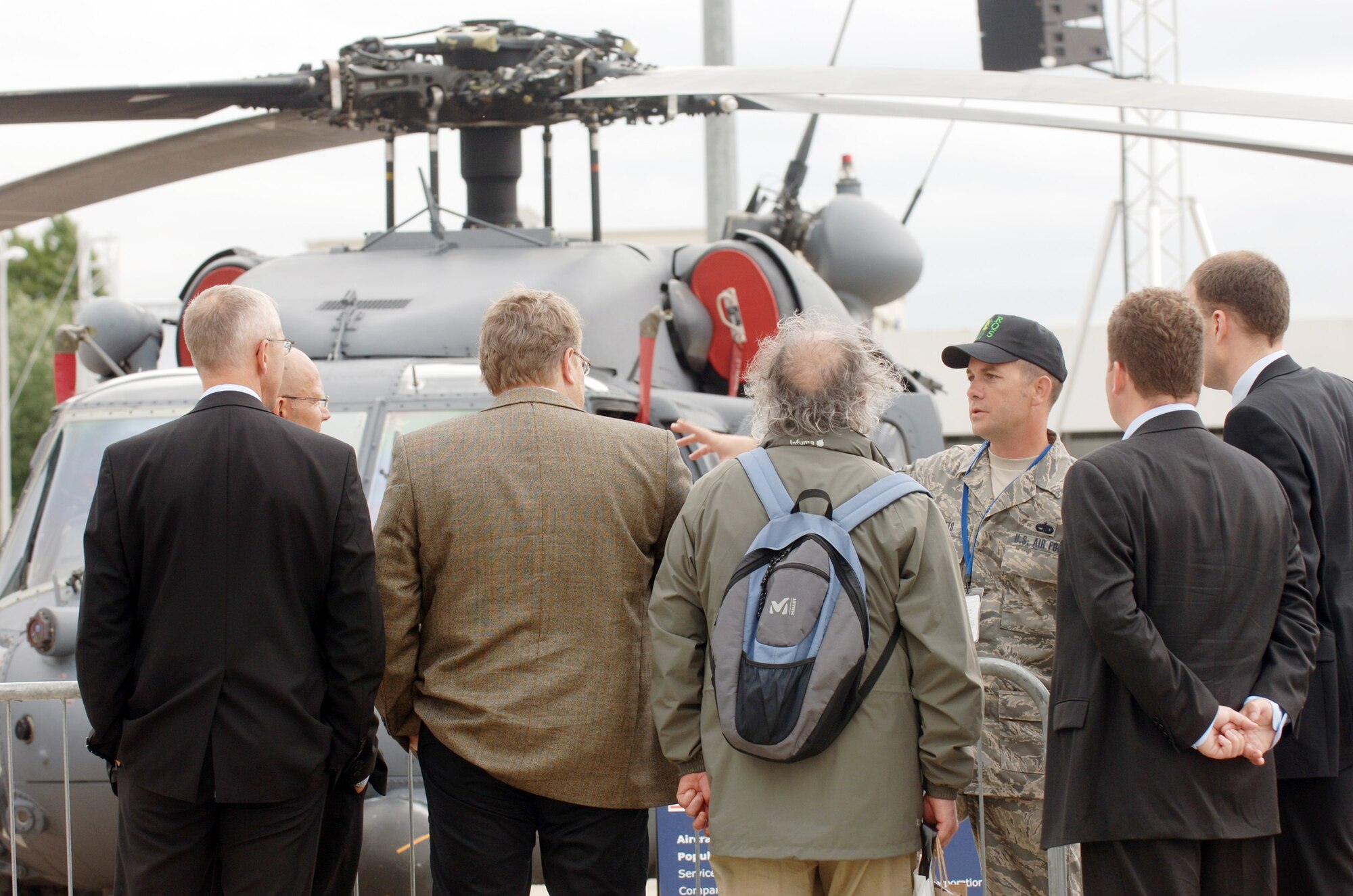 Tech. Sgt. Benjamin Pitts discusses the capabilities of the HH-60 Pave Hawk combat search and rescue helicopter during the Paris Air Show 2009 June 18 at Le Bourget, France. The aircraft and crew are assigned to the 41st Rescue Squadron from Moody Air Force Base, Ga. Sergeant Pitts is a Pave Hawk maintainer. (Defense Department photo/Master Sgt. Scott Wagers)