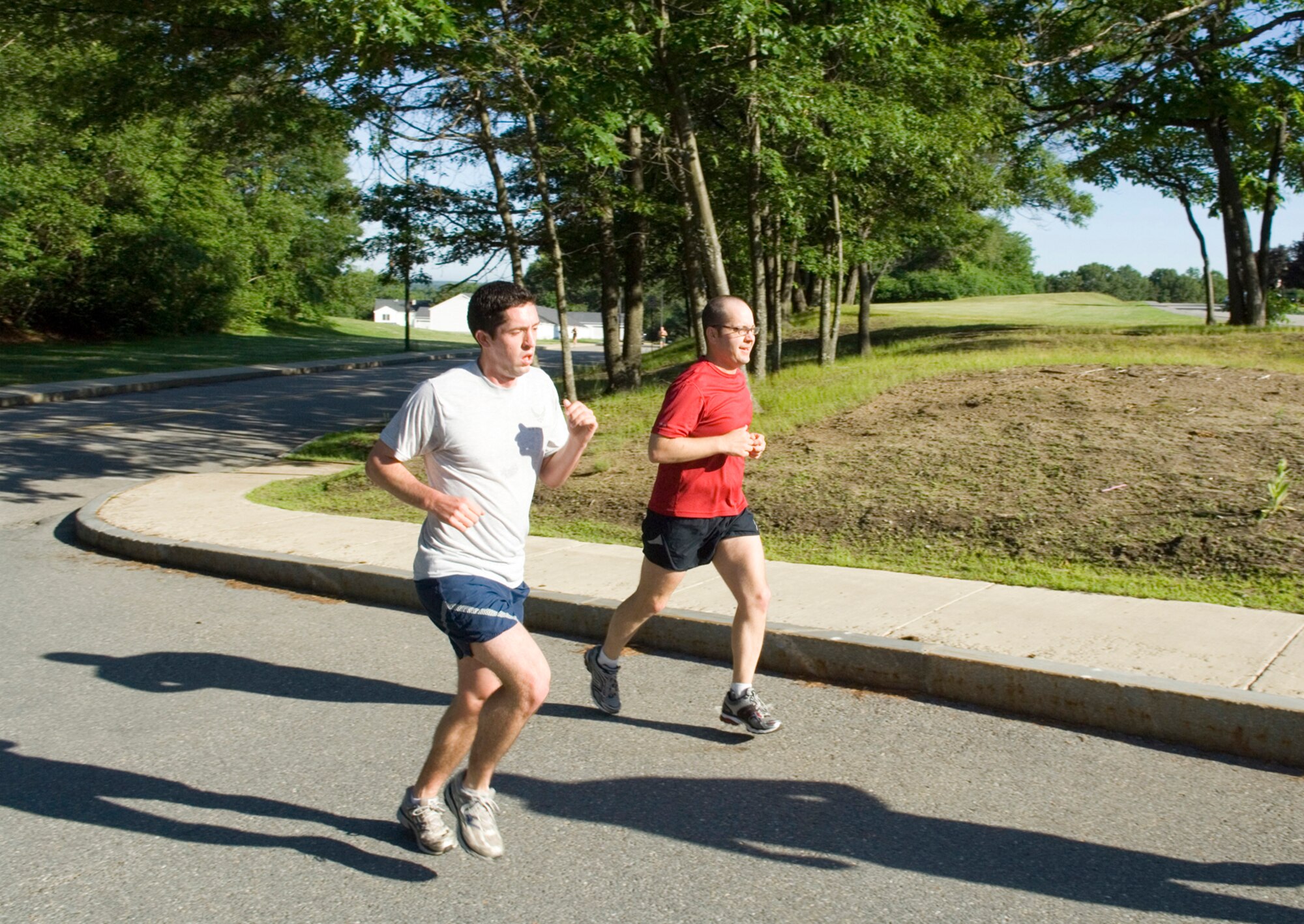 Second Lt. Greg Ferry (left), 66th Comptroller Squadron, and Tech. Sgt. Jeremy Grant, U.S. Air Force Band of Liberty, run ahead of the pack during the Summer Thunder 10K Fun Run, held June 17. Sergeant Grant subsequently won the race, finishing in 49 minutes, 24 seconds.  (U.S. Air Force photo by Rick Berry) 