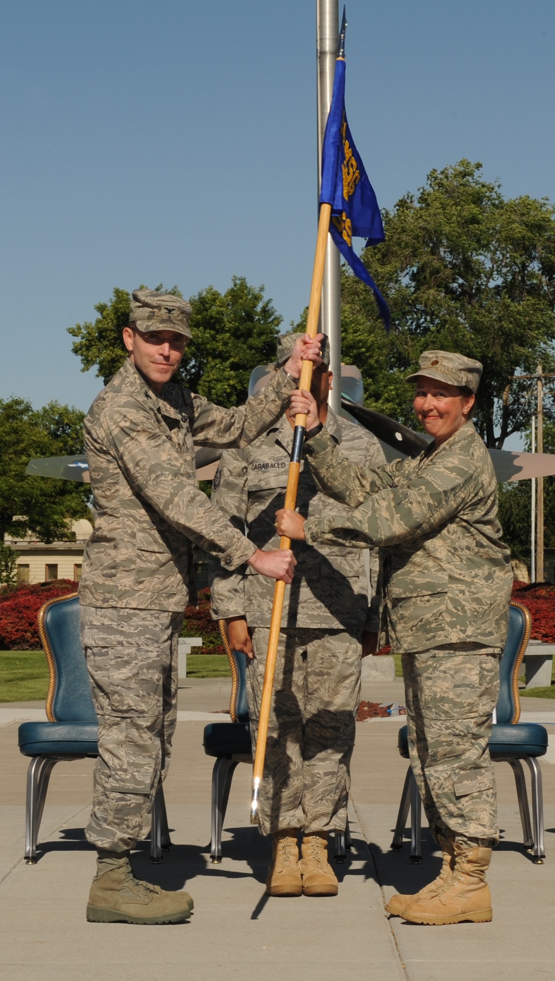 MOUNTAIN HOME AIR FORCE BASE, Idaho-- Col. Jeffery Maxwell, 366th Mission Support Group commander, passes the new 366th Force Support Squadron guidon to Maj. Eileen Kirkland, 366th FSS commander, June 23 during a ceremony at Holt Park. The ceremony officially deactivated the 366th MSS and redesignated the 366th SVS as the 366th FSS. (U.S. Air Force photo/ Airman 1st Class Renishia Richardson)