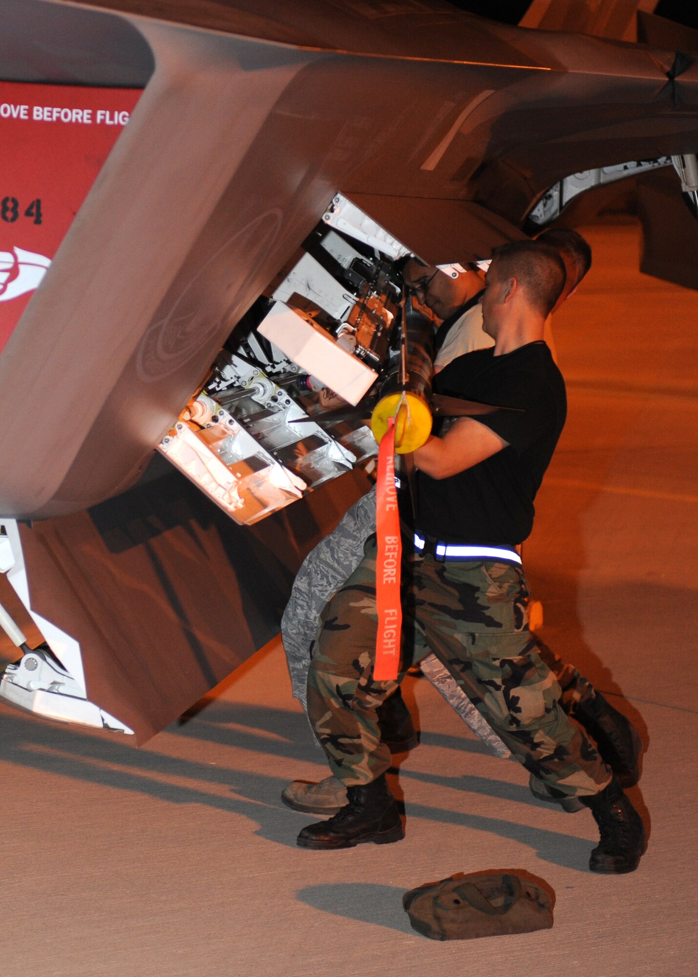 Airman from the 49th Aircraft Maintenance Squadron load an AIM-9 Sidewinder onto a F-22A Raptor, during the Weapons System Evaluation Program (WSEP), Holloman Air Force Base, N.M., June 24. Many Air Force fighter aircraft are participating in this evaluation. The F-22As at Holloman are being evaluated on the accuracy of various weapons systems. (U.S. Air Force photo/Senior Airman Michael Means)
