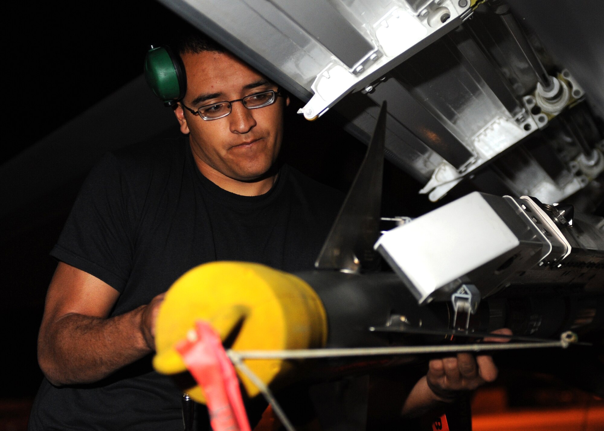 Senior Airman Toby Hernandez, 49th Aircraft Maintenance Squadron loads an AIM-9 Sidewinder onto a F-22A Raptor, during the Weapons System Evaluation Program (WSEP), Holloman Air Force Base, N.M., June 24. Many Air Force fighter aircraft are participating in this evaluation. This is the first time F-22As from Holloman have been loaded with live munitions. (U.S. Air Force photo/Senior Airman Michael Means)